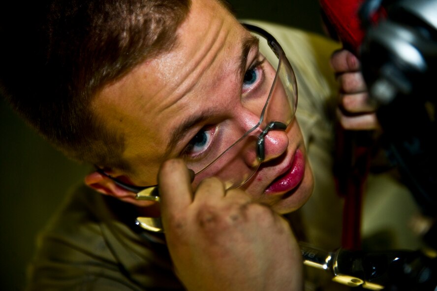 Senior Airman Sean Donnelly, 5th Maintenance Squadron aerospace propulsion technician takes a closer look while he assembles a B-52H Stratofortress engine aft mount at Minot Air Force Base, N.D., Dec. 4, 2013. After graduating technical training at Sheppard Air Force Base, Texas, Airmen are proficient in maintaining, inspecting and troubleshooting aircraft engines, small gas turbine engines and engine ground support equipment.  (U.S. Air Force photo/Senior Airman Brittany Y. Auld)