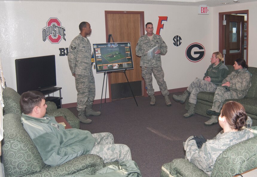 Staff Sgt. Shaun Haynes, 321st Missile Squadron chef,  and Staff Sgt. Clifford Cochran, 321st MS facility manager, welcome CGOs to the Kilo-01 Missile Alert Facility to give them a safety brief and tell them about their roles at the MAF Dec. 9, 2013. (U.S. Air Force photo by Airman 1st Class Jason Wiese)