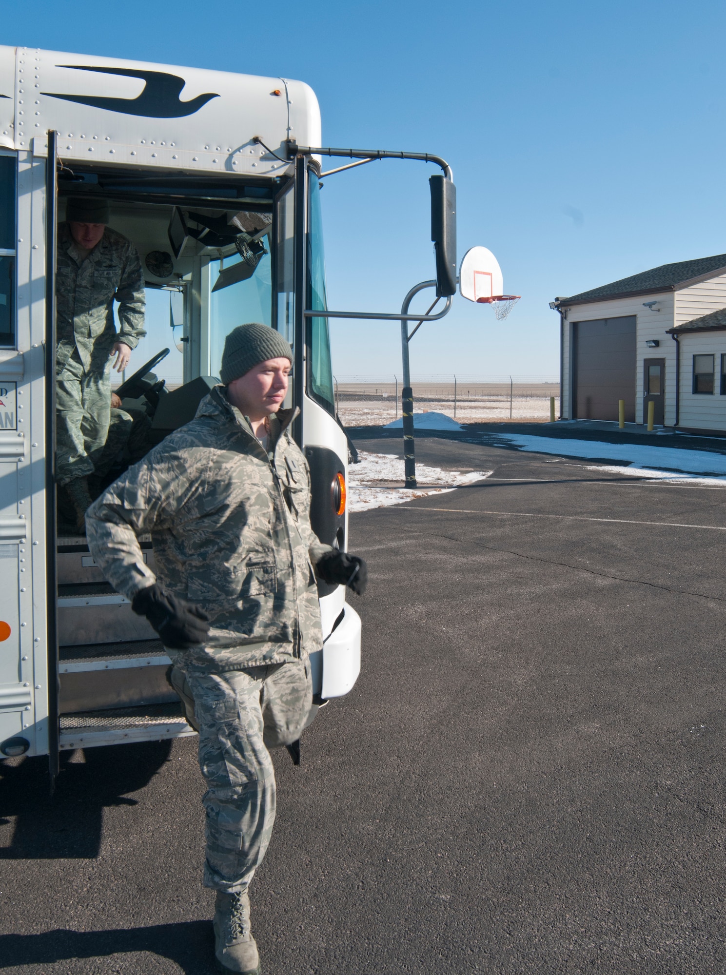 First Lt. Jason McLaughlin, 90th Force Support Squadron, exits the bus that brought him and other 90th Missile Wing CGOs to Kilo-01 Missile Alert Facility in Dix, Neb., Dec. 9, 2013, for a tour of the facility. The tour allowed CGOs not directly involved in missile operations to become familiar with the mission they support every day. (U.S. Air Force photo by Airman 1st Class Jason Wiese)