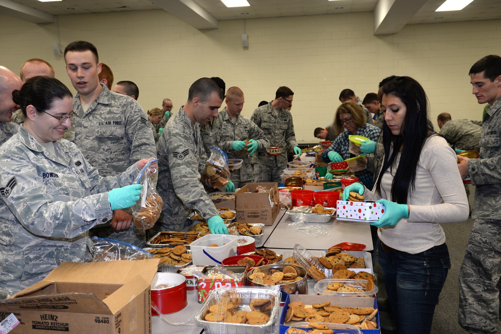 U.S. Air Force Airmen and civilian volunteers fill bags of cookies for Airmen and Soldiers living in dorms on base, Dec. 5, 2013, Shaw Air Force Base, S.C. More than 3,000 dozen cookies were donated by the Sumter, S.C. residents for this annual event.  (U.S. Air Force photo by Airman 1st Class Jonathan Bass/Released)