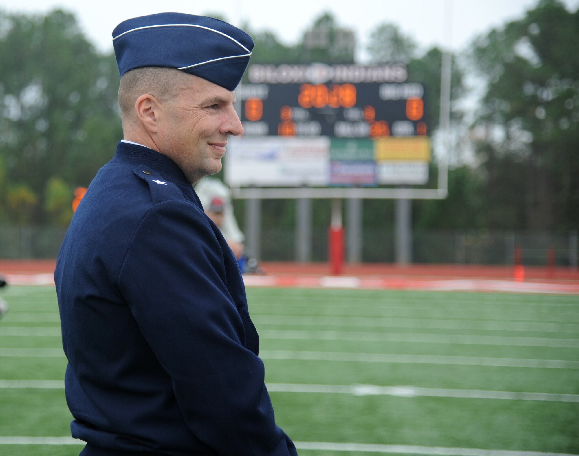 Brig. Gen. Patrick Higby, 81st Training Wing commander, Keesler Air Force Base, Miss., takes his place on the field for the coin toss during a pre-game celebration at the 2013 Mississippi Bowl at the Biloxi High School football stadium Dec. 8, 2013. The Keesler Honor Guard and Airmen carrying the 50-State flags also participated in the pre-game celebration.  (U.S. Air Force photo by Kemberly Groue)