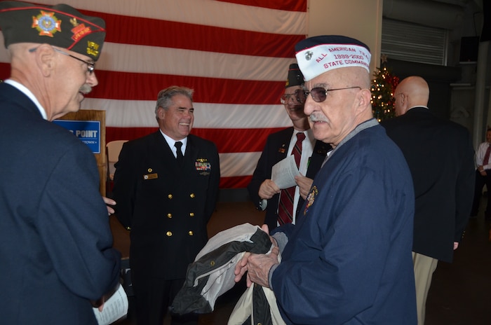 Navy Capt. Timothy Sparks, Joint Base Charleston deputy commander, chats with World War II and Pearl Harbor veterans during the 72nd Pearl Harbor Anniversary Memorial Service Dec. 7, 2013, onboard USS Yorktown at Patriots Point, Mt. Pleasant, S.C. Sparks provided the keynote address to more than 200 guests which included three Pearl Harbor survivors. During the ceremony, the names of 25 men from South Carolina who were killed in the attack were read, and a bell tolled for each of their names. (Courtesy photo/Holly Jackson)