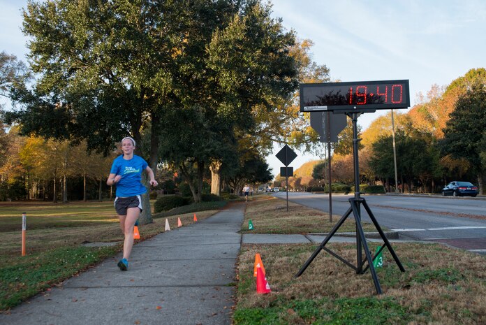 Jessica Ramsey, spouse of 2nd Lt. Phil Ramsey, 628th Civil Engineer Squadron programmer, runs toward the finish line during the Commander’s Challenge 5K Run Dec. 6, 2013, at Joint Base Charleston – Air Base, S.C. The Commander's Challenge is held monthly to test Team Charleston's fitness abilities. Ramsey was the top female runner with a time of 19:40. (U.S. Air Force photo/ Senior Airman Ashlee Galloway)