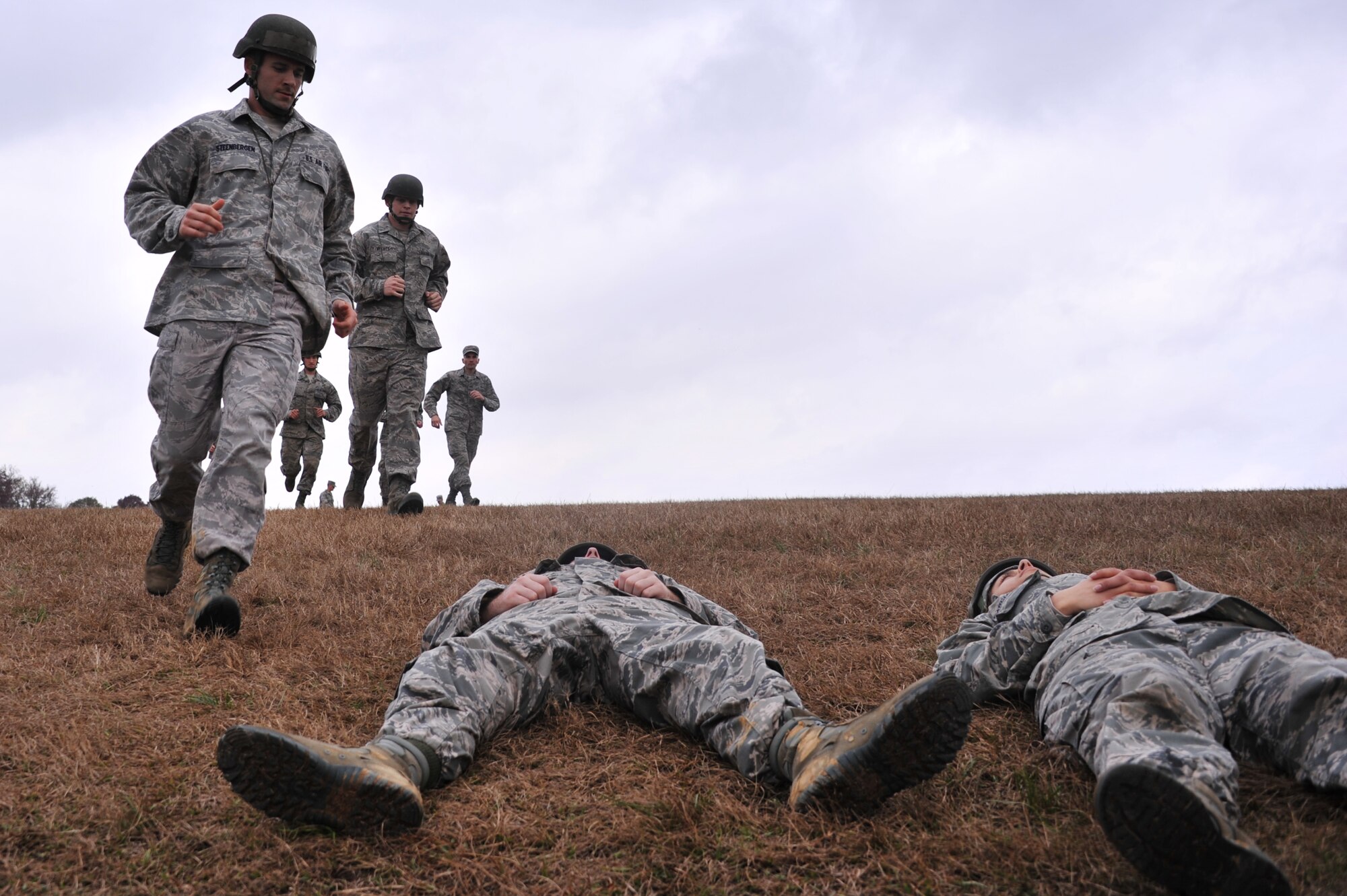 Class 14-03 officer trainees rush carry to mock-injured team members to safety during the basic expeditionary leadership problem solving course Dec. 4, 2013, at Maxwell Air Force Base, Ala. During this course the officer candidates are each tasked to take lead in solving a problem they would possibly run into in a situation in the operational Air Force. The trainees must complete each exercise within 20 minutes. (U.S. Air Force photo by Staff Sgt. Natasha Stannard)