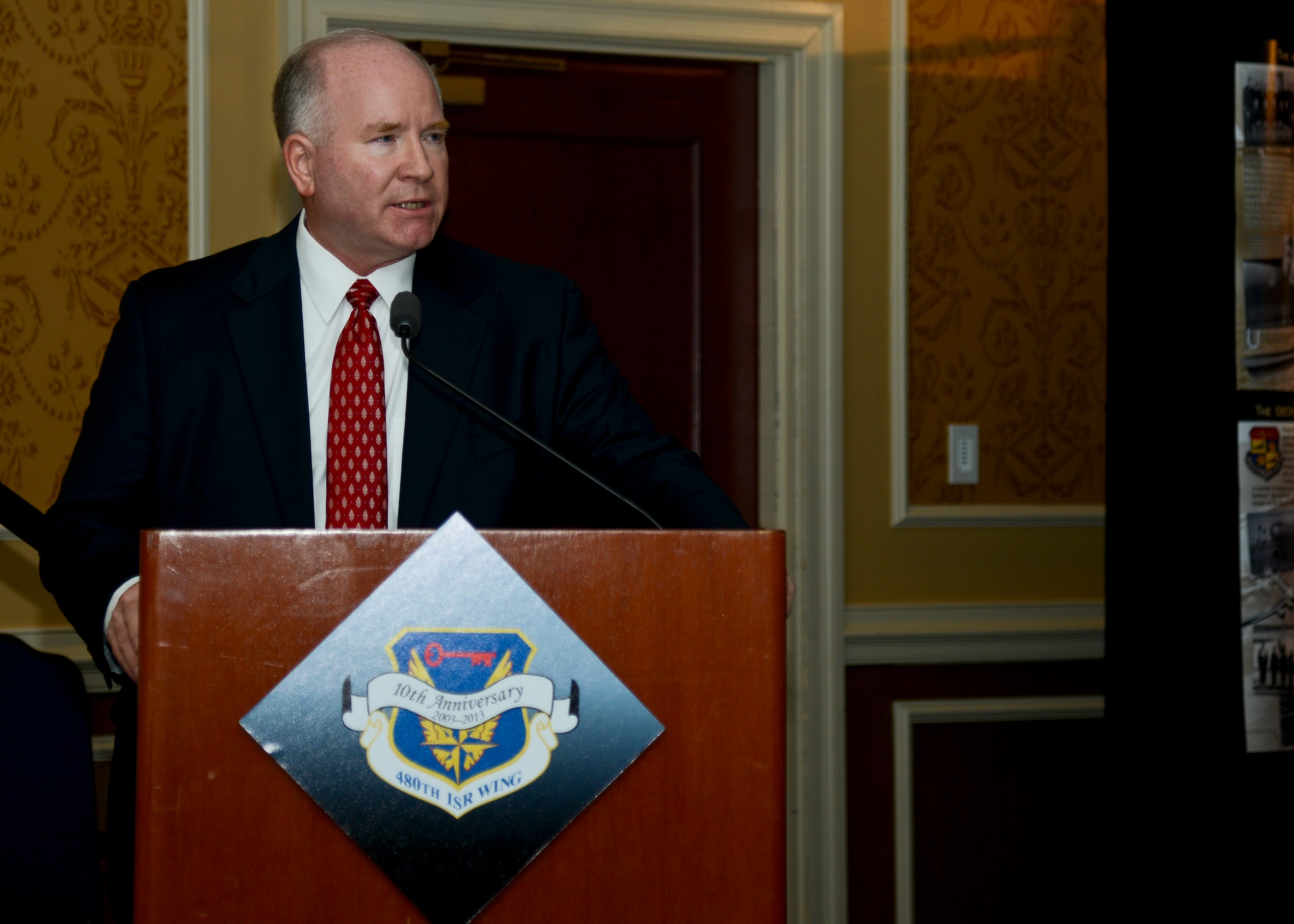 Retired U.S. Air Force Brig. Gen. Larry K. Grundhauser, the first commander of the 480th Intelligence, Surveillance and Reconnaissance Wing, speaks at the Heritage Observance Celebration at Langley Air Force Base, Va., Dec. 5, 2013.  As a part of the anniversary celebration, ten distinguished wing veterans received a tour of the 480th ISR Wing and 497th ISR Group facilities. (U.S. Air Force photo by Airman 1st Class Victoria H. Taylor/Released)