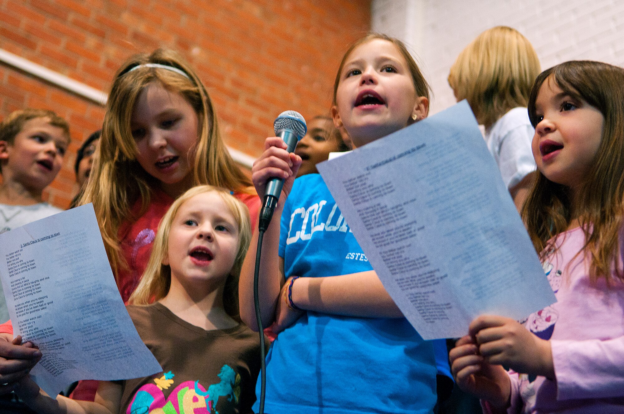 Children from the F.E. Warren Youth Center school-age program sing “Rudolph the Red-Nose Reindeer” during the annual F.E. Warren tree lighting ceremony in the Fall Hall Community Center, Dec. 6, 2013. (U.S. Air Force photo by R.J. Oriez) 