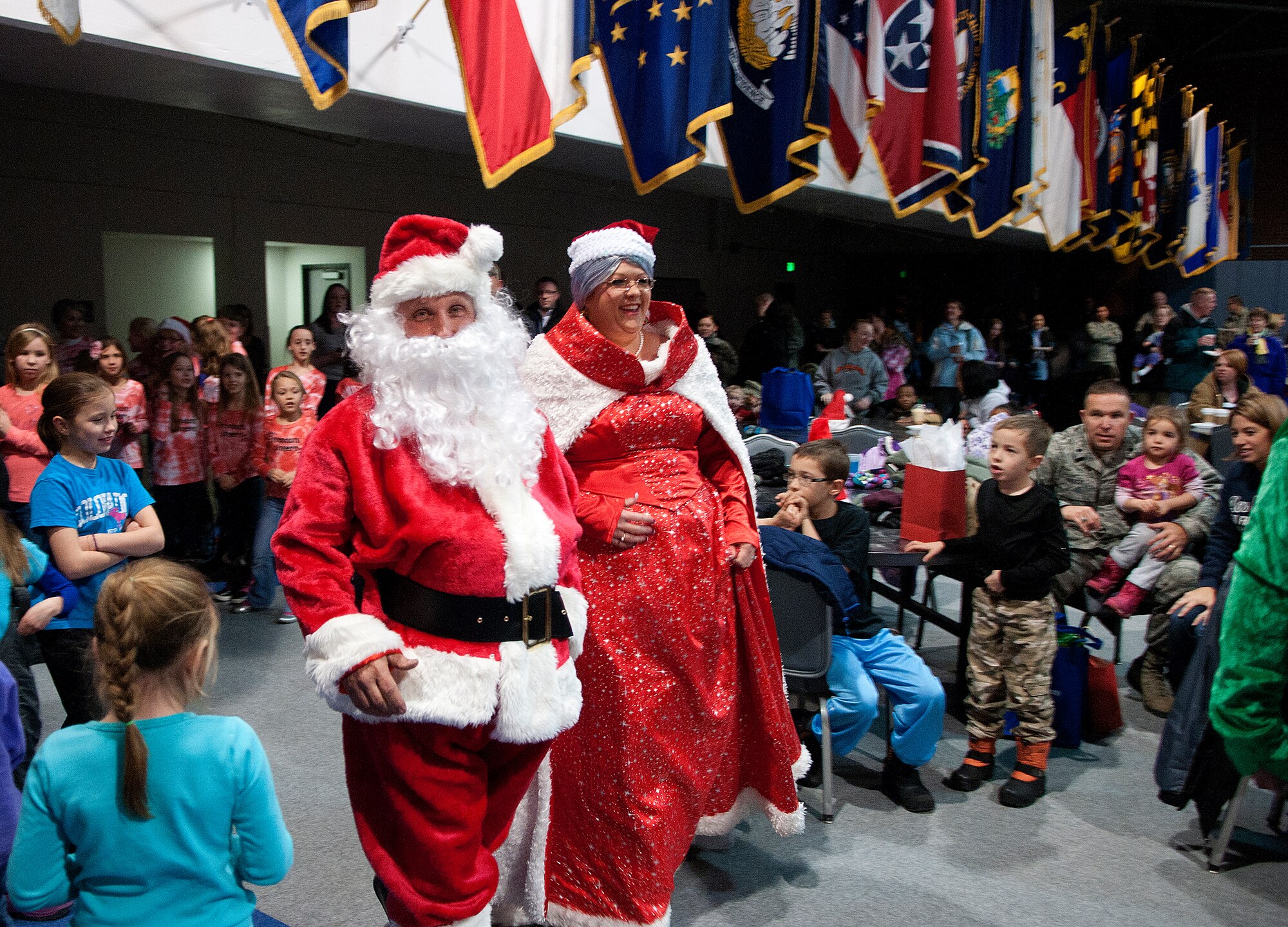 The guests-of-honor of the F.E. Warren Christmas tree lighting ceremony, Santa and Mrs. Claus, arrive at the Fall Hall Community Center Dec. 6, 2013. The Clauses posed for photos and visited with children after the official lighting. (U.S. Air Force photo by R.J. Oriez))