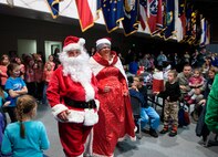 The guests-of-honor of the F.E. Warren Christmas tree lighting ceremony, Santa and Mrs. Claus, arrive at the Fall Hall Community Center Dec. 6, 2013. The Clauses posed for photos and visited with children after the official lighting. (U.S. Air Force photo by R.J. Oriez))