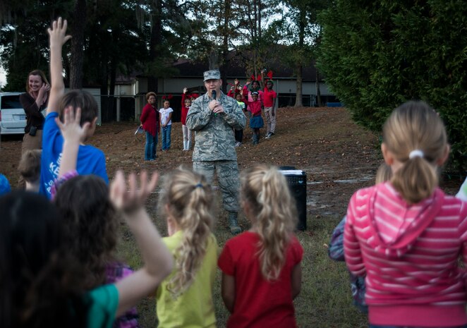 Col. Jeffrey DeVore, Joint Base Charleston commander, speaks at the JB Charleston - Air Base Christmas tree lighting ceremony Dec. 4, 2013, officially kicking off the holiday season. The ceremony included Christmas Carols, refreshments and the announcement of the Air Base Holiday Card Contest winner, the 628th Logistics Readiness Squadron Petroleum Oil and Lubricants fuels team. (U.S. Air Force photo/ Senior Airman Dennis Sloan)