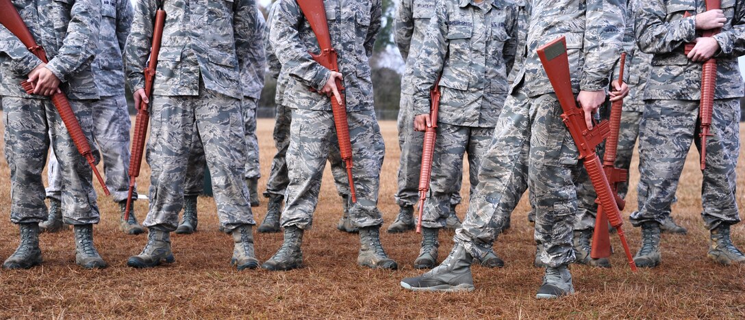 Members of Officer Training School class 14-03 await their task during the basic expeditionary leadership problem solving course Dec. 4, 2013, at Maxwell Air Force Base, Ala. During this course, the officer candidate students are each tasked to take lead in solving problems they would possibly run into in the operational Air Force. (U.S. Air Force photo by Staff Sgt. Natasha Stannard)