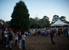 The Joint Base Charleston – Air Base Christmas tree is lit, officially opening the holiday season Dec. 4, 2013. The ceremony included Christmas Carols, refreshments and the announcement of the Air Base Holiday Card Contest winner. This year, the 628th Logistics Readiness Squadron Petroleum Oil and Lubricants fuels team placed first in the contest. (U.S. Air Force photo/ Senior Airman Dennis Sloan) 

