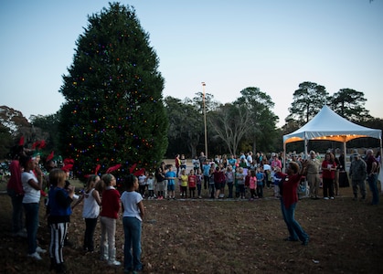 The Joint Base Charleston – Air Base Christmas tree is lit, officially opening the holiday season Dec. 5, 2013. The ceremony included Christmas Carols, refreshments and the announcement of the Air Base Holiday Card Contest winner, the 628th Logistics Readiness Squadron Petroleum Oil and Lubricants fuels team. (U.S. Air Force photo/ Senior Airman Dennis Sloan)