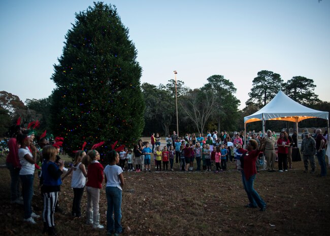 The Joint Base Charleston – Air Base Christmas tree is lit, officially opening the holiday season Dec. 5, 2013. The ceremony included Christmas Carols, refreshments and the announcement of the Air Base Holiday Card Contest winner, the 628th Logistics Readiness Squadron Petroleum Oil and Lubricants fuels team. (U.S. Air Force photo/ Senior Airman Dennis Sloan)