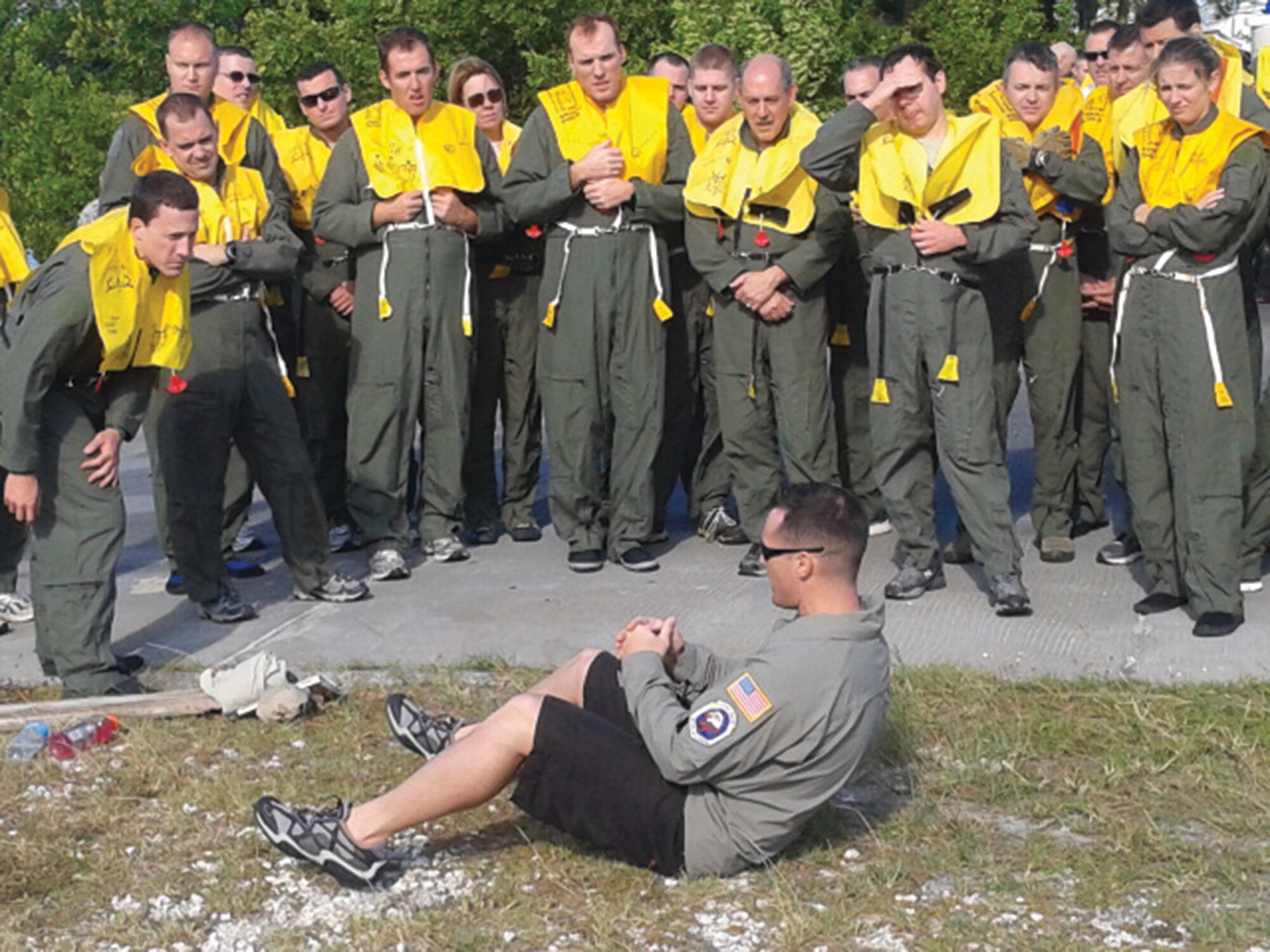 WRIGHT-PATTERSON AIR FORCE BASE, Ohio - SERE (survival, evade, resist, and escape) instructor Tech. Sgt. Joseph White, 96th Operations Support Squadron, Eglin Air Force Base, Fla., gives a demonstration on proper body position for parachute drags during water survival training Nov. 14. Aircrew personnel were instructed in survival at sea, parachute entanglement procedures, signaling procedures, parachute drag escape procedures,  methods and techniques for evasion in hostile territory.(U.S. Air Force photo/Senior Master Sgt. Timothy Reuber)