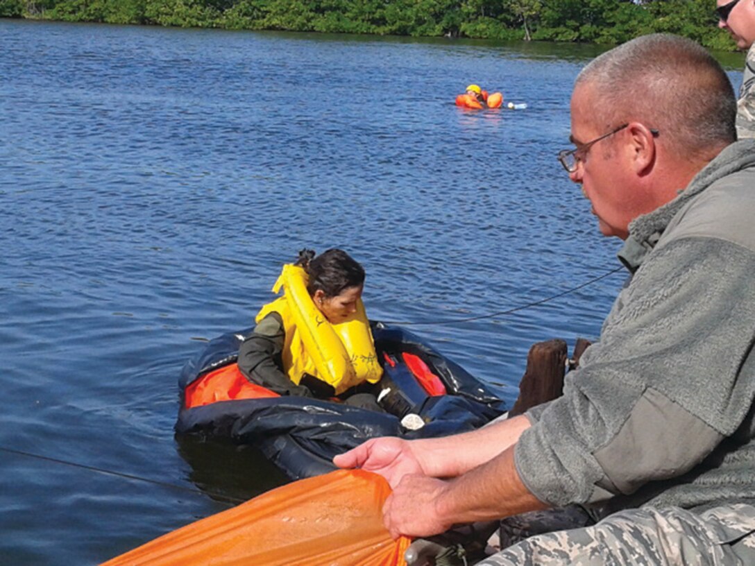 WRIGHT-PATTERSON AIR FORCE BASE, Ohio - Master Sgt. Gary Hanby, 445th Operations Support Squadron aircrew flight equipment assistant NCO in charge, instructs Senior Master Sgt. Pamela Brocklehurst, 89th Airlift Squadron loadmaster, on the proper use of a one man life raft and parachute entanglement during water survival training Nov. 14. Approximately 62 Airmen from AES, OSS  and the 89th Airlift Squadron attended the Nov. 13-17 water survival/escape and evasion training held at the Naval Air Station in Key West, Fla. (U.S. Air Force photo/Senior Master Sgt. Timothy Reuber)

