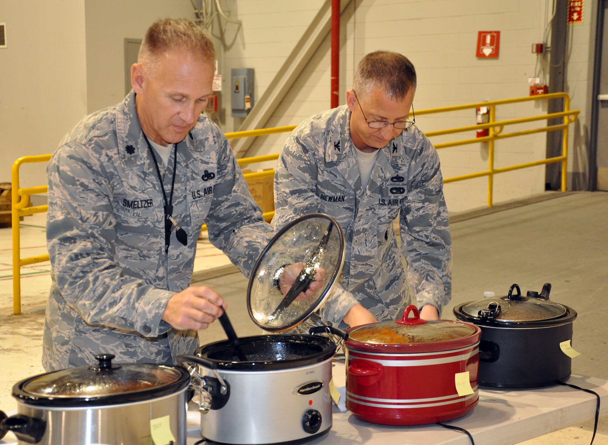 WRIGHT-PATTERSON AIR FORCE BASE, Ohio – Lt. Col. Jay Smeltzer, 445th Aircraft Maintenance Squadron commander, and Col. Brett Newman, 445th Maintenance Group commander, prepares to sample some chili while serving as judges for the 445th Airlift Wing Chili Cook-off. The event raised $391 for the Combined Federal Campaign. (U.S. Air Force photo/Stacy Vaughn)
