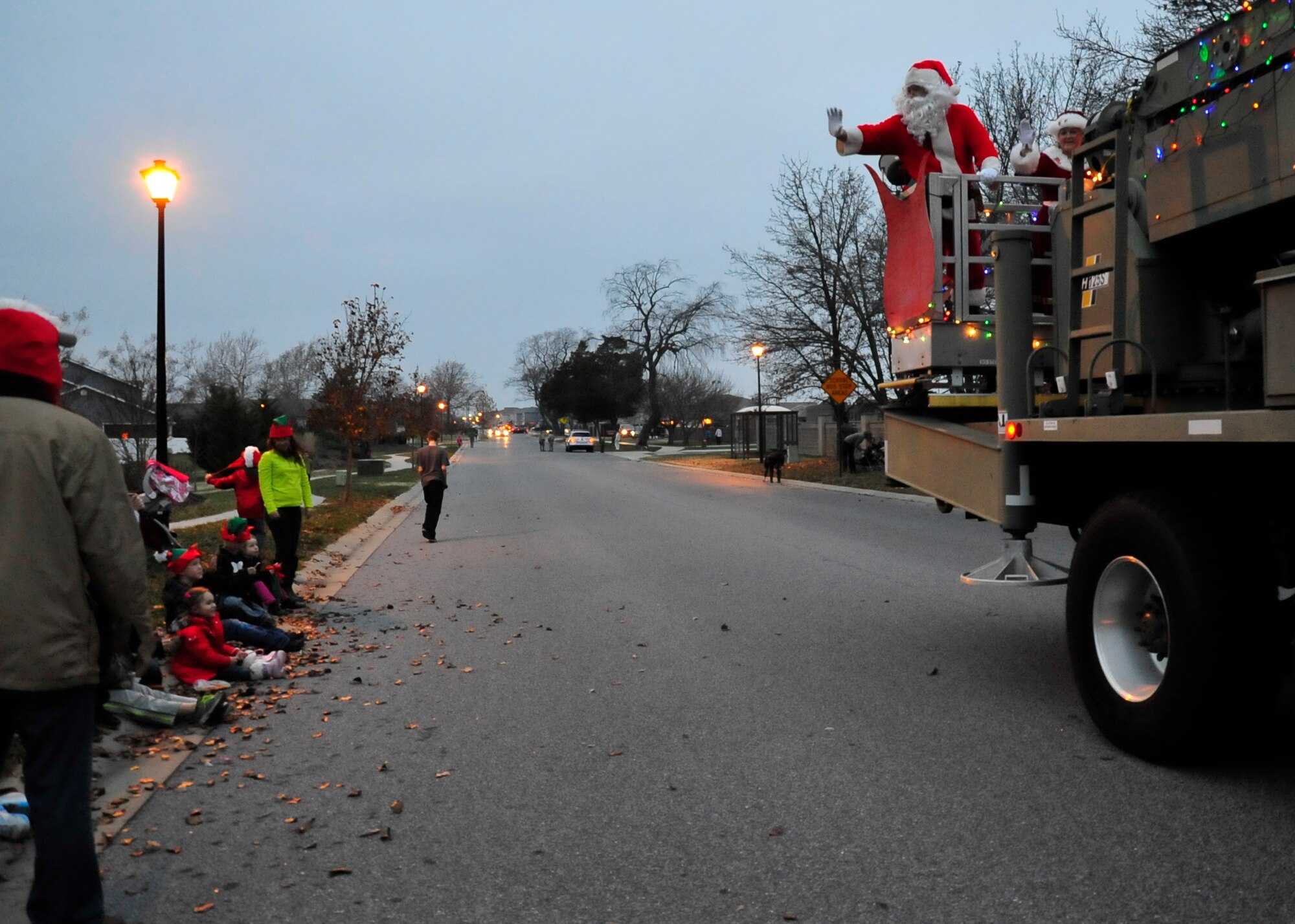 Santa Claus waves at families during the Christmas parade on base housing Dec. 5, 2013, at Dover Air Force Base, Del. The parade was followed by a tree lighting ceremony at the base chapel. (U.S. Air Force photo/Airman 1st Class William Johnson)   