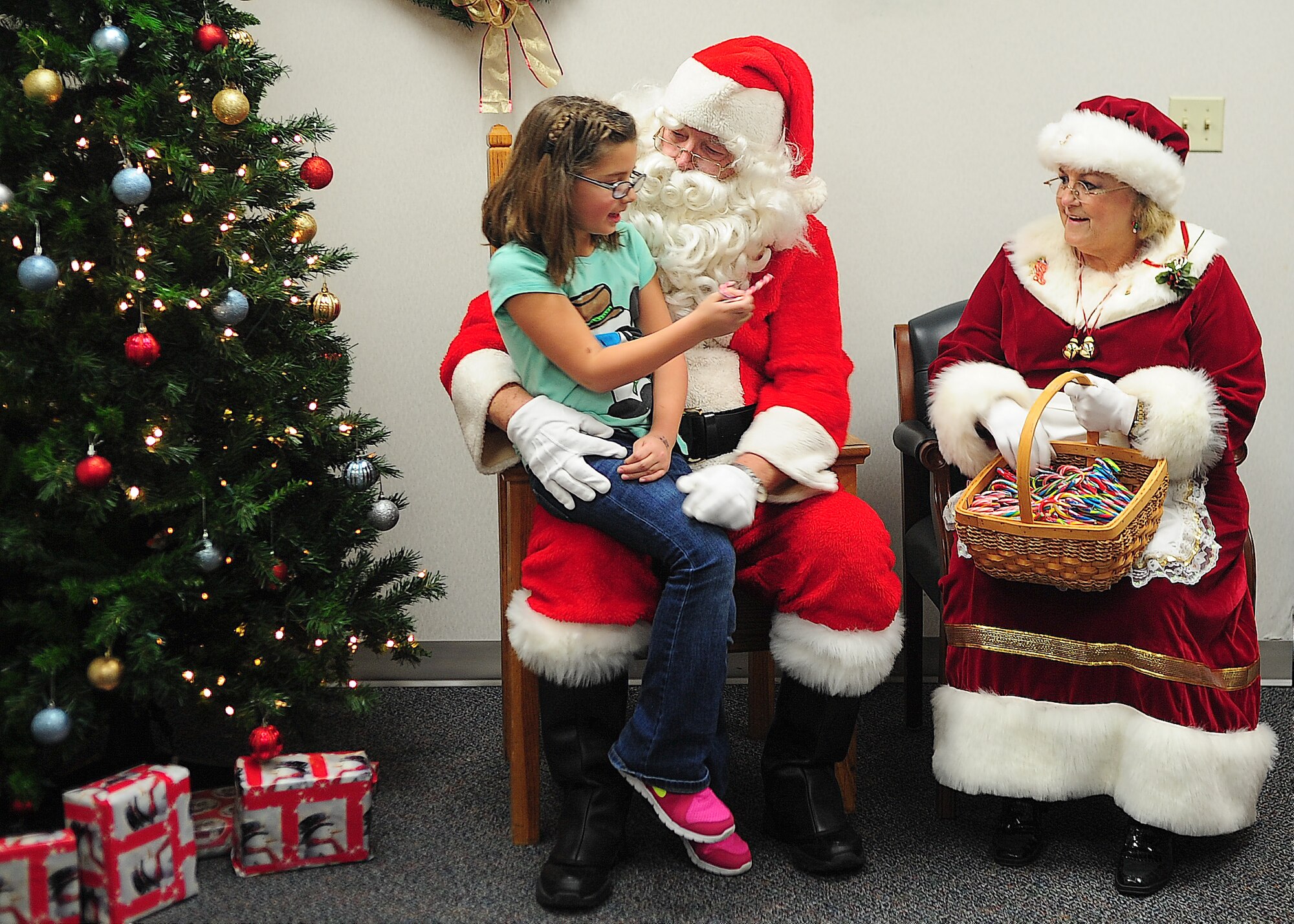 Jasmin Fox talks to Santa Claus and Mrs. Claus Dec. 5, 2013, at the base chapel on Dover Air Force Base, Del. Santa stayed after the tree lighting ceremony to talk to all the children. (U.S. Air Force photo/Airman 1st Class Ashlin Federick)
