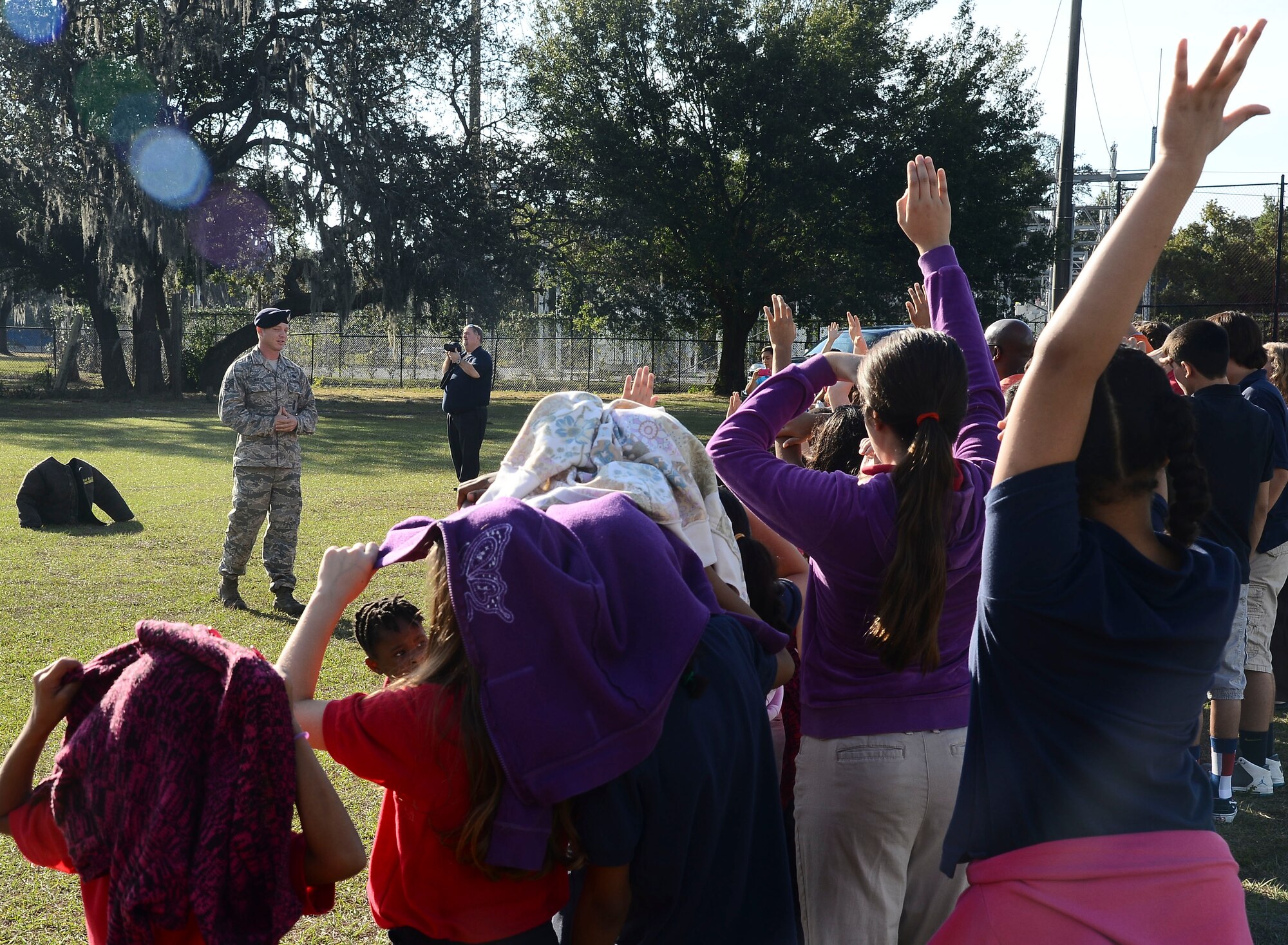 Tampa Adventist Academy students ask Staff Sgt Shannon Hutto, 6th Security Force Squadron military working dog trainer, questions regarding the military working dog demonstration, Dec. 4, 2013, in Tampa, Fla. This was the first time Tampa Adventist Academy held an event of this nature. (U.S. Air Force photo by Senior Airman Melanie Bulow-Gonterman/Released)