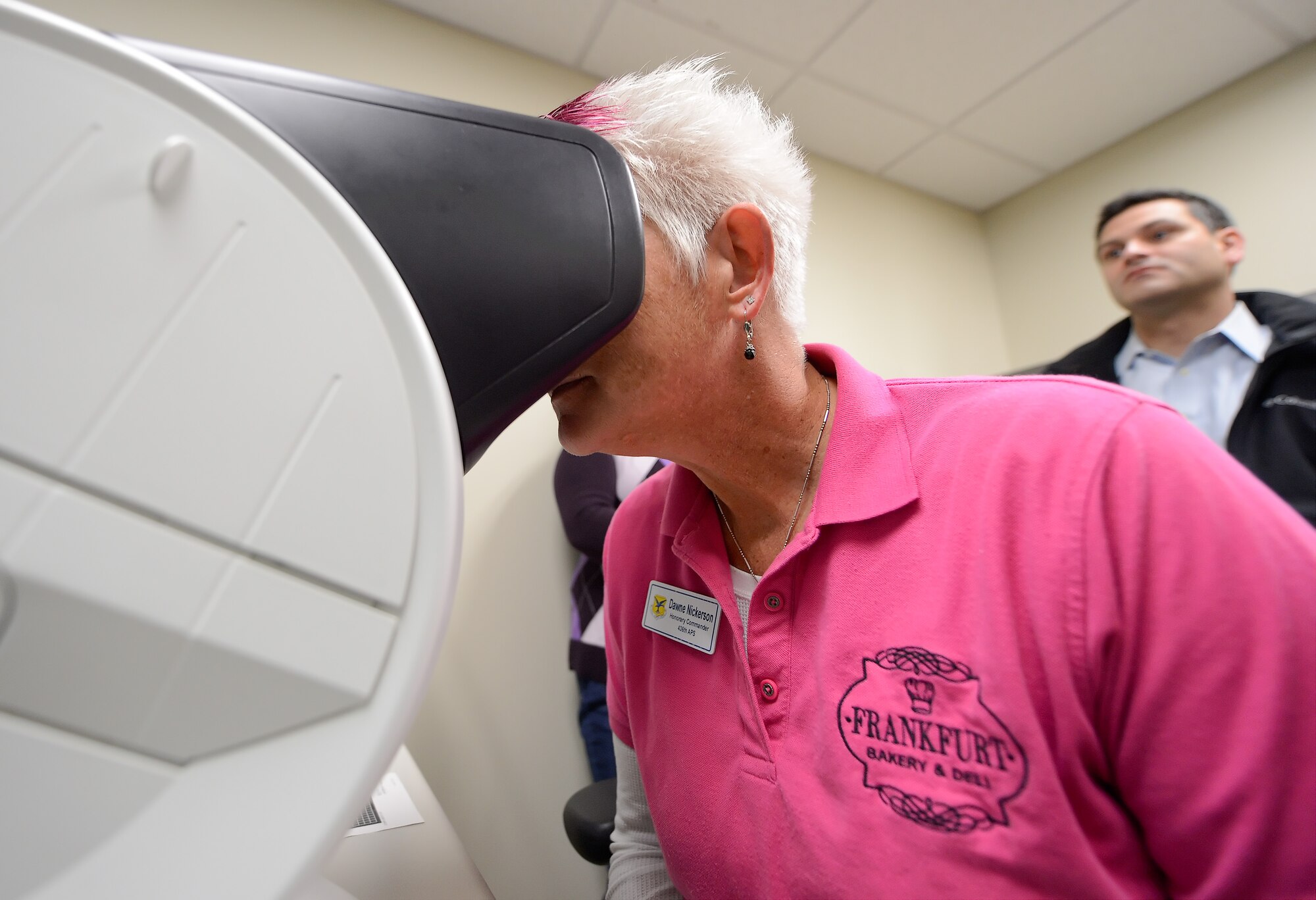 Dawne Nickerson, 436th Aerial Port Squadron honorary commander, looks in to a vision test device used to determine color blindness at the 436th Aeromedical Squadron on Dec. 4, 2013, Dover Air Force Base, Del. Dover AFB honorary commanders received an in-depth tour of the 436th Medical Group. (U.S. Air Force photo/Greg L. Davis)