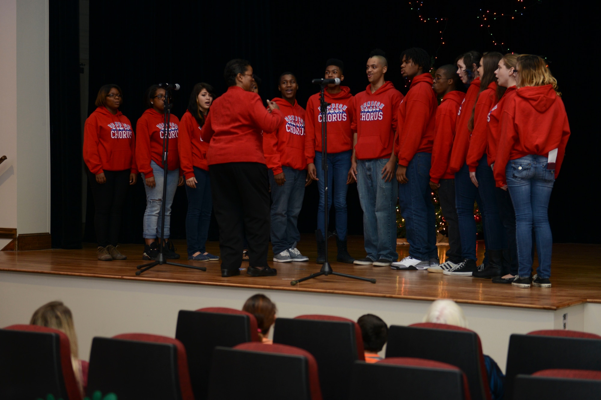 Members of the Denbigh High School vocal ensemble perform holiday songs during the Christmas tree lighting ceremony at Fort Eustis, Va., Dec. 6, 2013. After the performance, guests visited Santa Claus, enjoyed snacks and watched the ceremonial lighting of the installation’s Christmas tree. (U.S. Air Force photo by Staff Sgt. Ciara Wymbs/Released)  