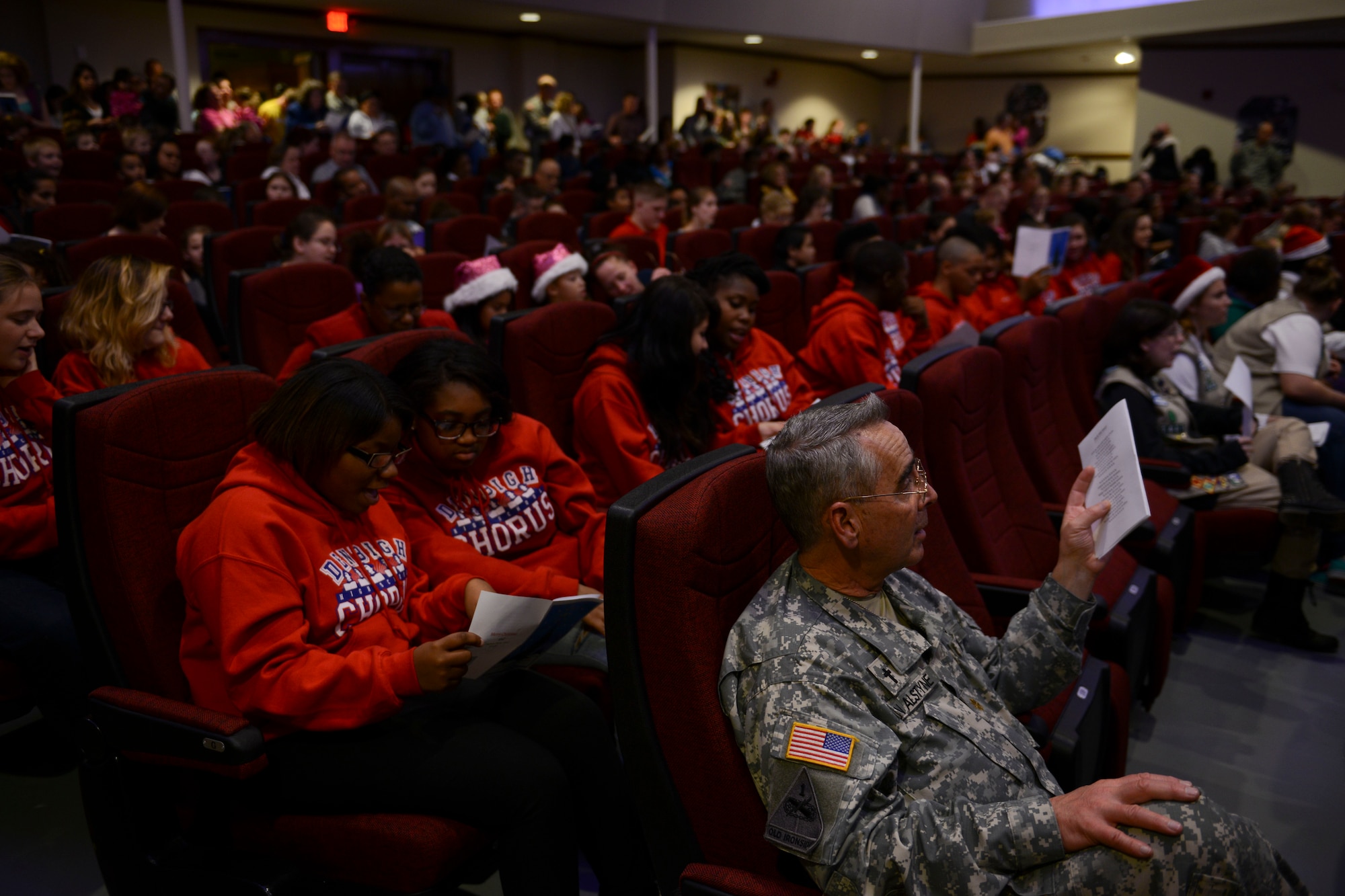 Attendees sing Christmas carols during the Christmas tree lighting ceremony at Fort Eustis, Va., Dec. 6, 2013. Guests sang along to holiday classics performed by the U.S. Army Training and Doctrine Command Band.  (U.S. Air Force photo by Staff Sgt. Ciara Wymbs/Released)