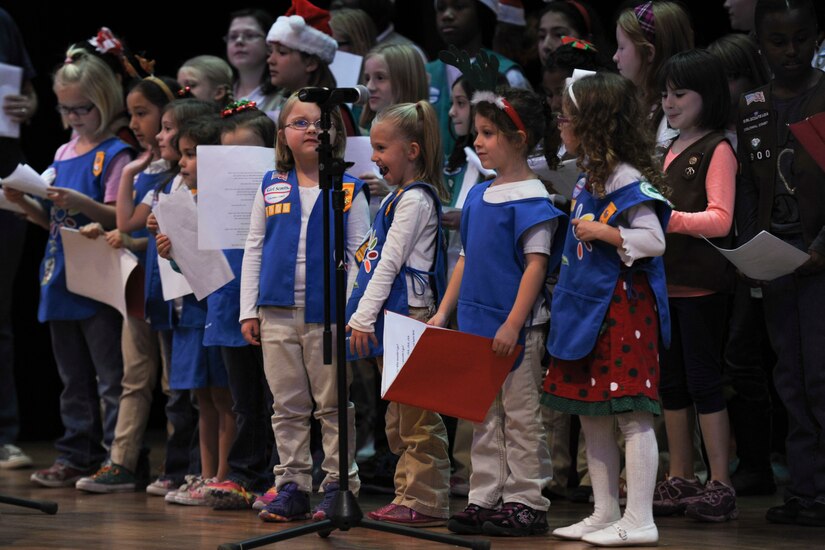 The Fort Eustis Girl Scouts perform Christmas carols during the Christmas tree lighting ceremony at Fort Eustis, Va., Dec. 6, 2013. The girl scouts performed “Jingle Bells” and “We Wish You a Merry Christmas” for event attendees. (U.S. Air Force photo by Staff Sgt. Ciara Wymbs/Released)