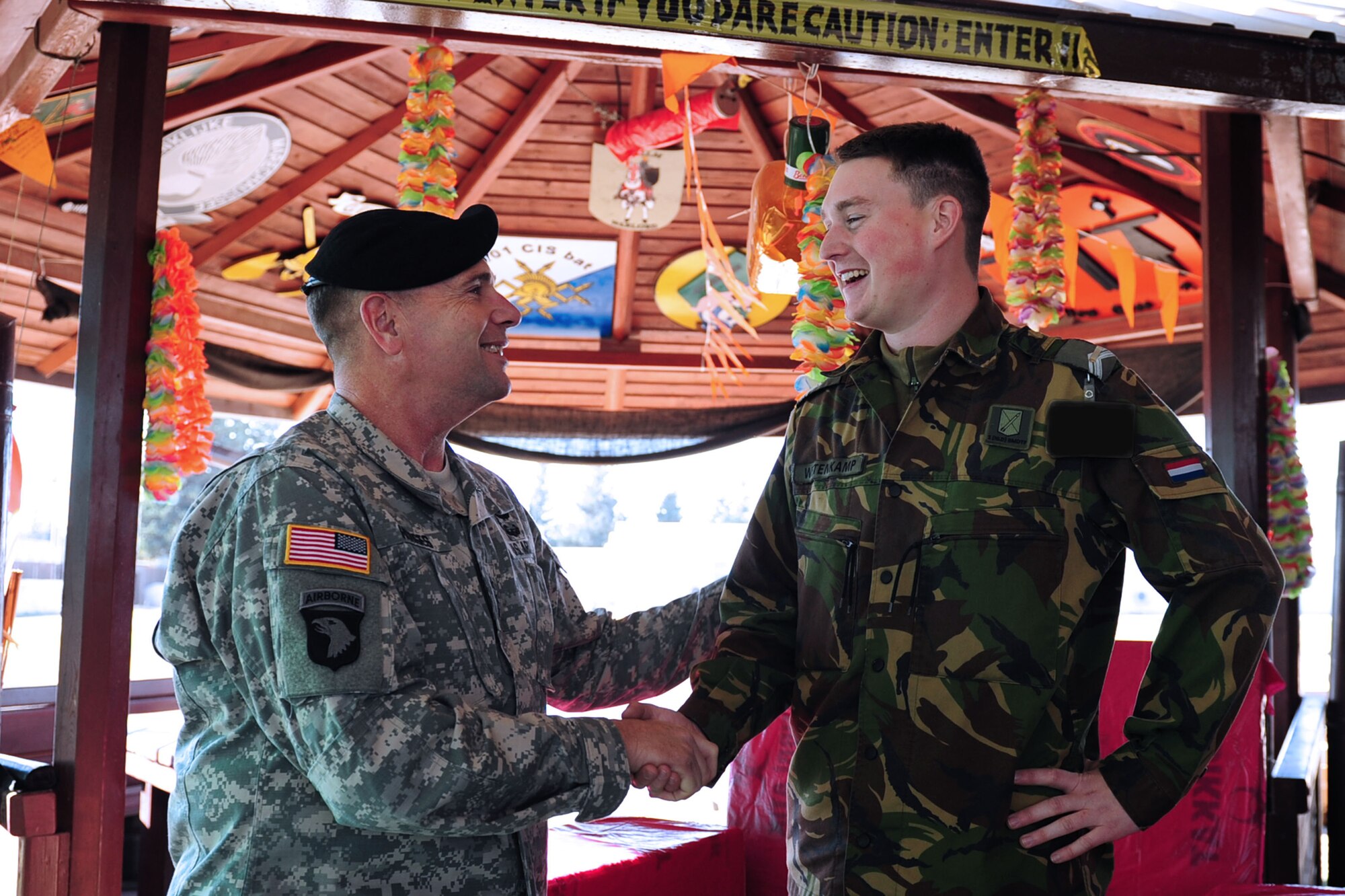 U.S. Army Lt. Gen. Frederick "Ben” Hodges, commander of NATO’s Allied Land Command, gives a coin to Dutch army Sgt. Dominick Wetenkamp, Dutch NCO in charge at Patriot Village Dec. 9, 2013, at Incirlik Air Base, Turkey.  Wetenkamp received a coin for his active work on the Patriot mission and for giving a tour of Patriot Village facilities. (U.S. Air Force photo by Airman 1st Class Nicole Sikorski/Released)