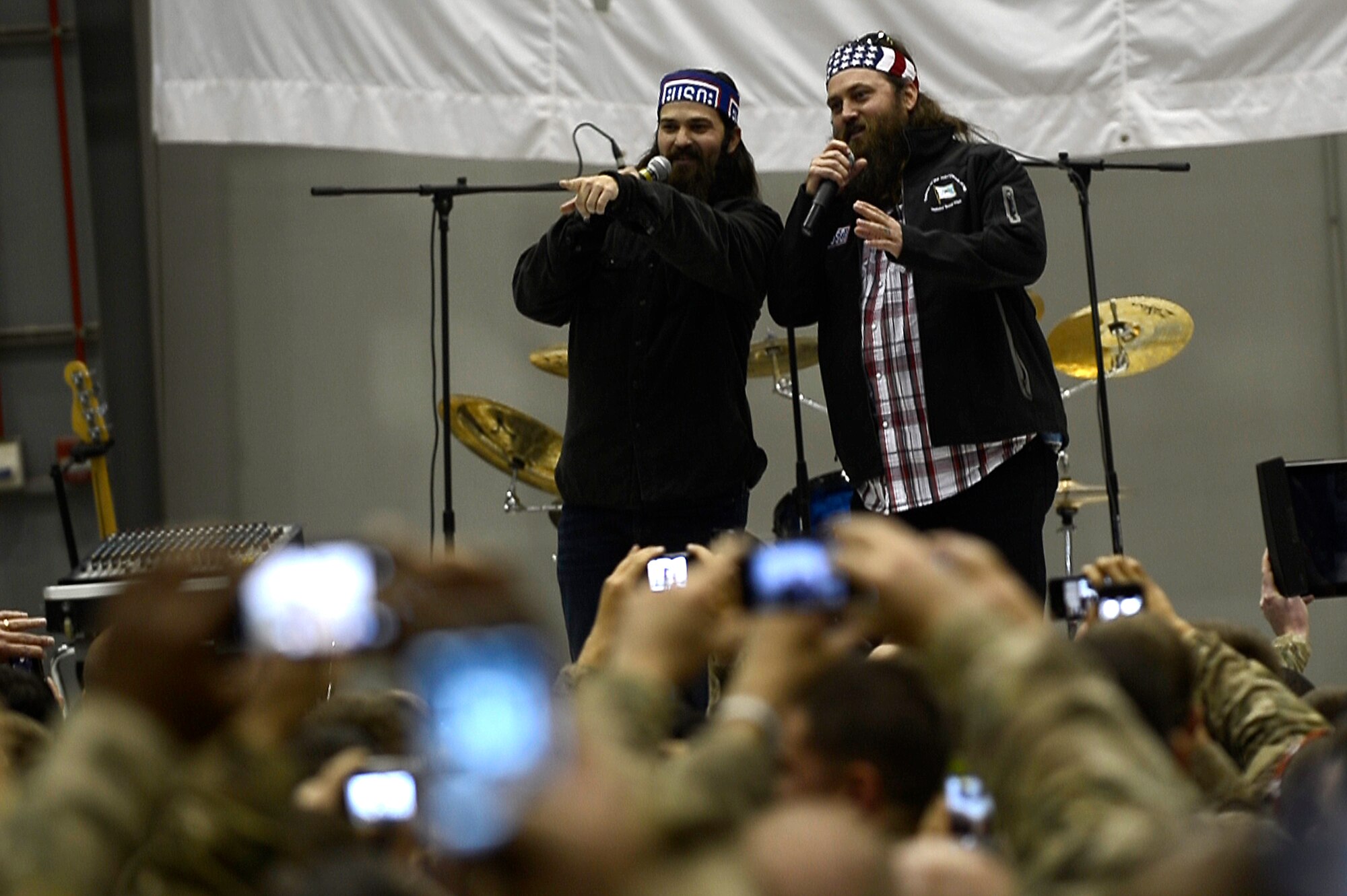 A&E show Duck Dynasty stars Jep and Willie Robertson greet the crowd during a USO Holiday Troop Visit at Bagram Airfield, Afghanistan, Dec. 9, 2013. Actress Alison Haislip, singer and songwriter Bridget Kelly, Washington Nationals Adam LaRoche, former New England Patriot Matt Light and radio personality Thomas “Nephew Tommy” Miles were among the other celebrities visiting with military personnel. (U.S. Air Force photo by Senior Airman Kayla Newman/Released)