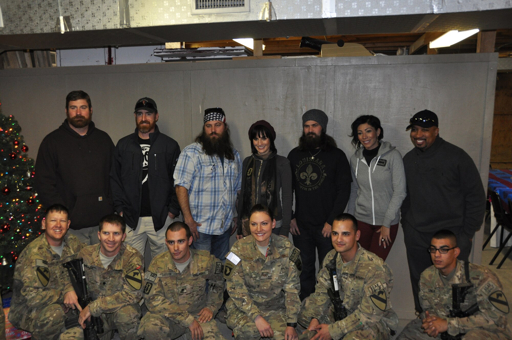 Servicemembers have a photo taken with former New England Patriots offensive tackle Matt Light, Washington Nationals first baseman Adam LaRoche, "Duck Dynasty" cast member Willie Robertson, former correspondent for NBC's “The Voice” Alison Haislip, "Duck Dynasty" cast member Jep Robertson, Grammy-winning singer and songwriter Bridget Kelly and actor and comedian Thomas “Nephew Tommy” Miles, at Bagram Airfield, Afghanistan, Dec. 10, 2013. Servicemembers, civilians and contractors were visited by the Chairman of the Joint Chiefs of Staff, Army Gen. Martin E. Dempsey, who led performers during the United Service Organization CJCS holiday troop visit here. ( (U.S. Air Force photo/Tech. Sgt. Rob Hazelett)