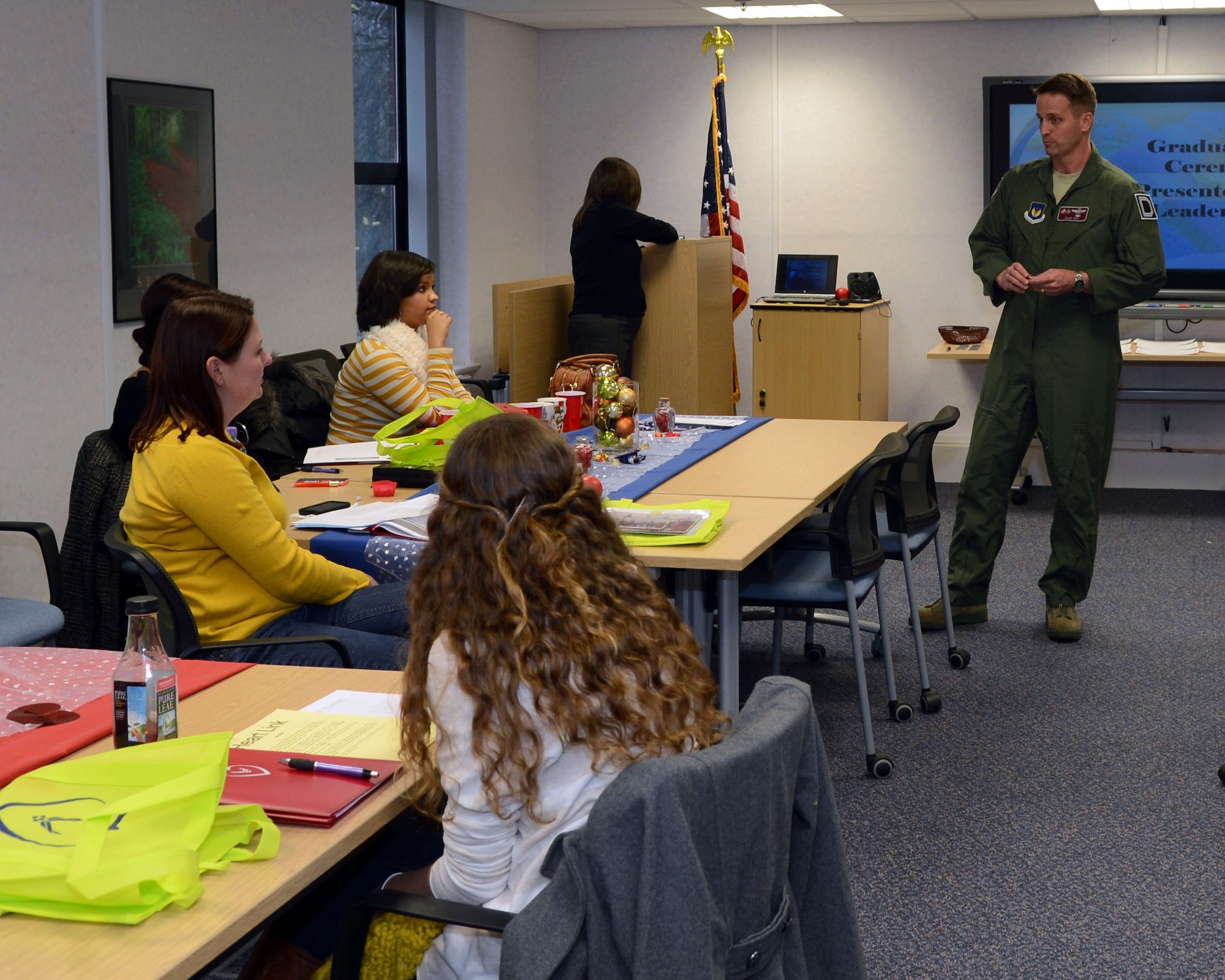 U.S. Air Force Col. David Cox, 100th Air Refueling Wing vice commander, talks to Team Mildenhall spouses before their graduation from the Heart Link program Dec. 6, 2013, at the Airman and Family Readiness Center on RAF Mildenhall, England. Heart Link is a full-day workshop where spouses are oriented to the military lifestyle and introduced to a variety of resources to help ease the transition. (U.S. Air Force photo by Airman 1st Class Jonathan Light/Released)