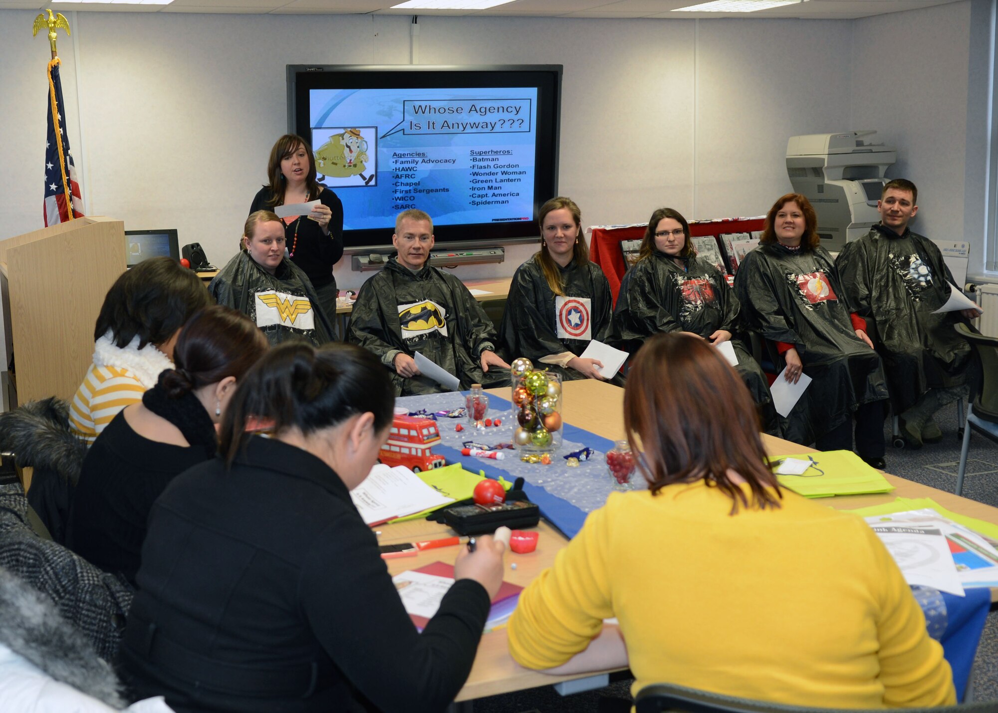 Team Mildenhall spouses play “Whose Agency is It Anyways” during the Heart Link program Dec. 6, 2013, at the Airman and Family Readiness Center on RAF Mildenhall, England. Heart Link is a full-day workshop where spouses are oriented to the military lifestyle and introduced to a variety of resources to help ease the transition. (U.S. Air Force photo by Airman 1st Class Jonathan Light/Released)