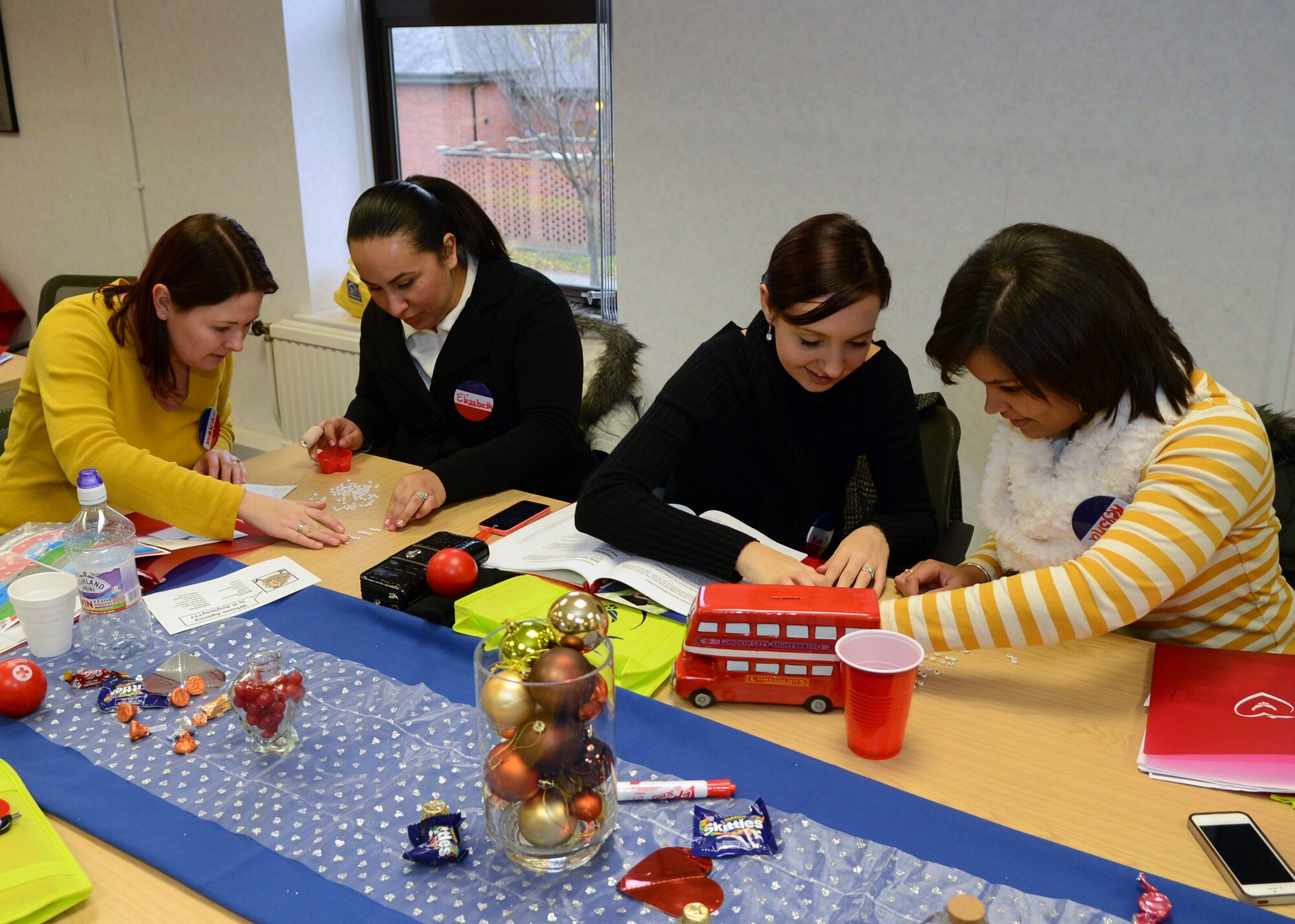 Team Mildenhall spouses participate in an acronym game during the Heart Link program Dec. 6, 2013, at the Airman and Family Readiness Center on RAF Mildenhall, England. The program helps spouses new to the military become more familiar with the military lifestyle. (U.S. Air Force photo by Airman 1st Class Jonathan Light/Released)