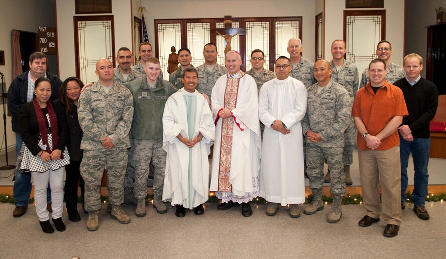 Bishop F. Richard Spencer, Auxiliary Bishop Archdiocese for the Military Services, USA, poses with members of the Kunsan Air Base Catholic community during a visit to the base Dec. 9, 2013.  Bishop Spencer serves as the Vicar for all military Chapels and U.S. State Department Embassies in Europe and Asia of the Archdiocese for the Military Services and is responsible for all the Catholics deployed or assigned in those parts of the world.  (U.S. Air Force photo by Tech. Sergeant Alex Griffin/Released