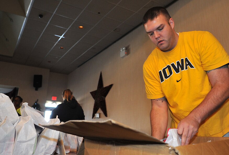 Staff Sgt. James Newcomb, 694th Intelligence Support Squadron project manager, packs a box with completed goodie bags for Operation Sweet Treat in the Officers’ Club at Osan Air Base, Republic of Korea, Dec. 7, 2013. Unaccompanied Airmen and Soldiers at both Osan and Kunsan Air Base will each receive a pack of holiday treats. (U.S. Air Force photo/Airman 1st Class Ashley J. Thum)