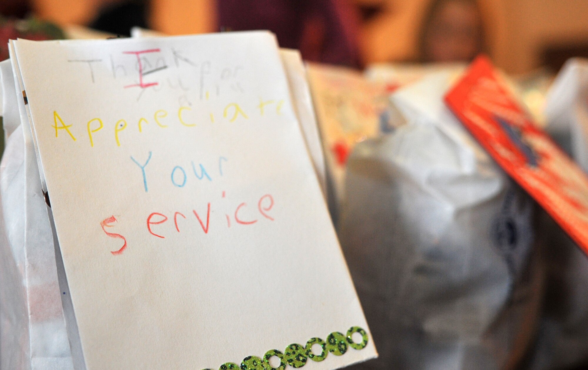A holiday greeting written by a “Little Mustang” is ready to deliver its message during Operation Sweet Treat in the Officers’ Club at Osan Air Base, Republic of Korea, Dec. 7, 2013. Each goodie bag was topped off with a card or other handmade message to remind unaccompanied service members that they are being thought of during the holidays. (U.S. Air Force photo/Airman 1st Class Ashley J. Thum)