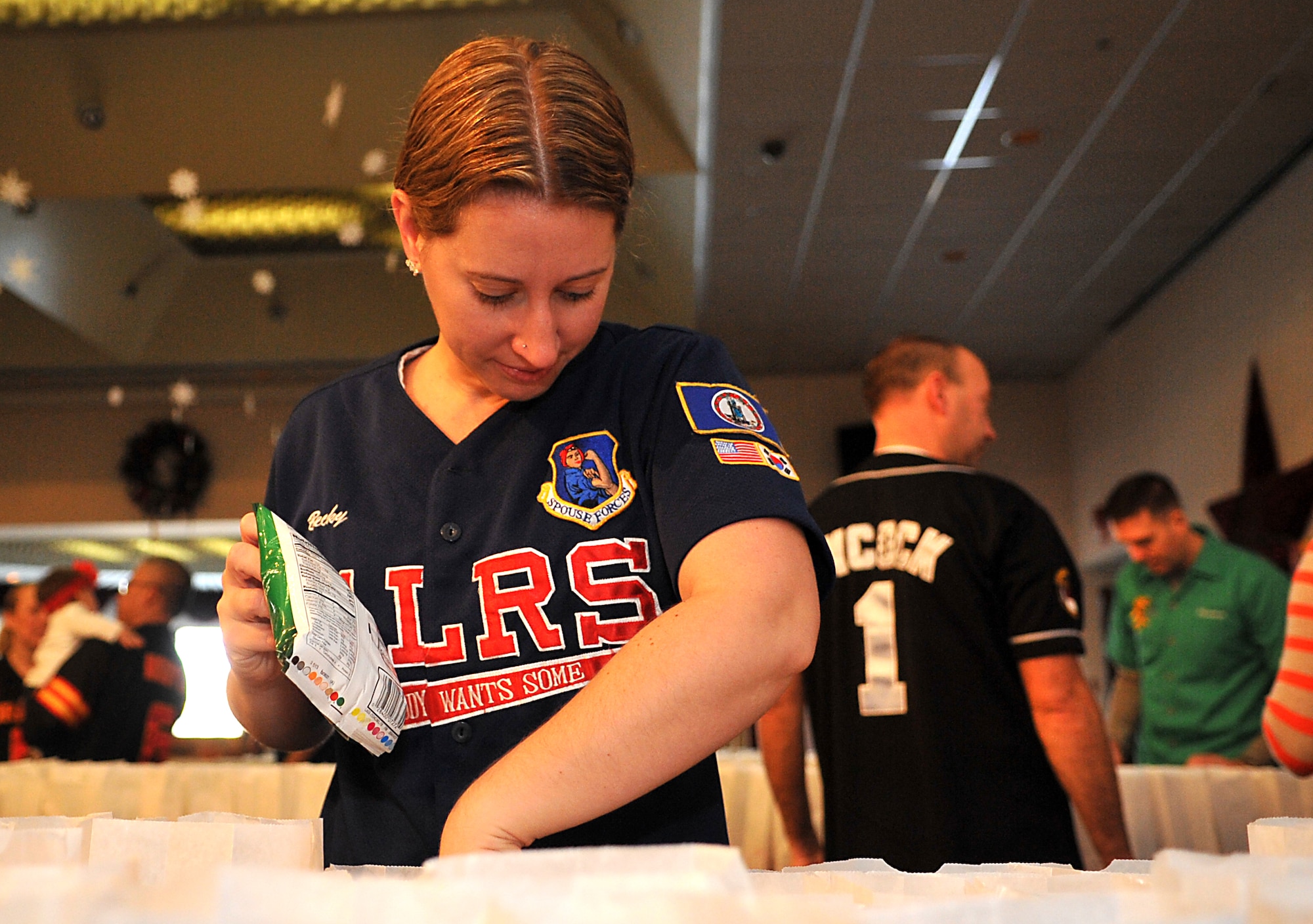 Becky Haler, spouse of Maj. Eric Haler, 51st Logistics Readiness Squadron commander, inspects goodie bags for the correct contents during Operation Sweet Treat in the Officers’ Club at Osan Air Base, Republic of Korea, Dec. 7, 2013. More than 350 volunteers assembled bags with cookies, candy, hot chocolate and other treats, along with a holiday greeting. (U.S. Air Force photo/Airman 1st Class Ashley J. Thum)
