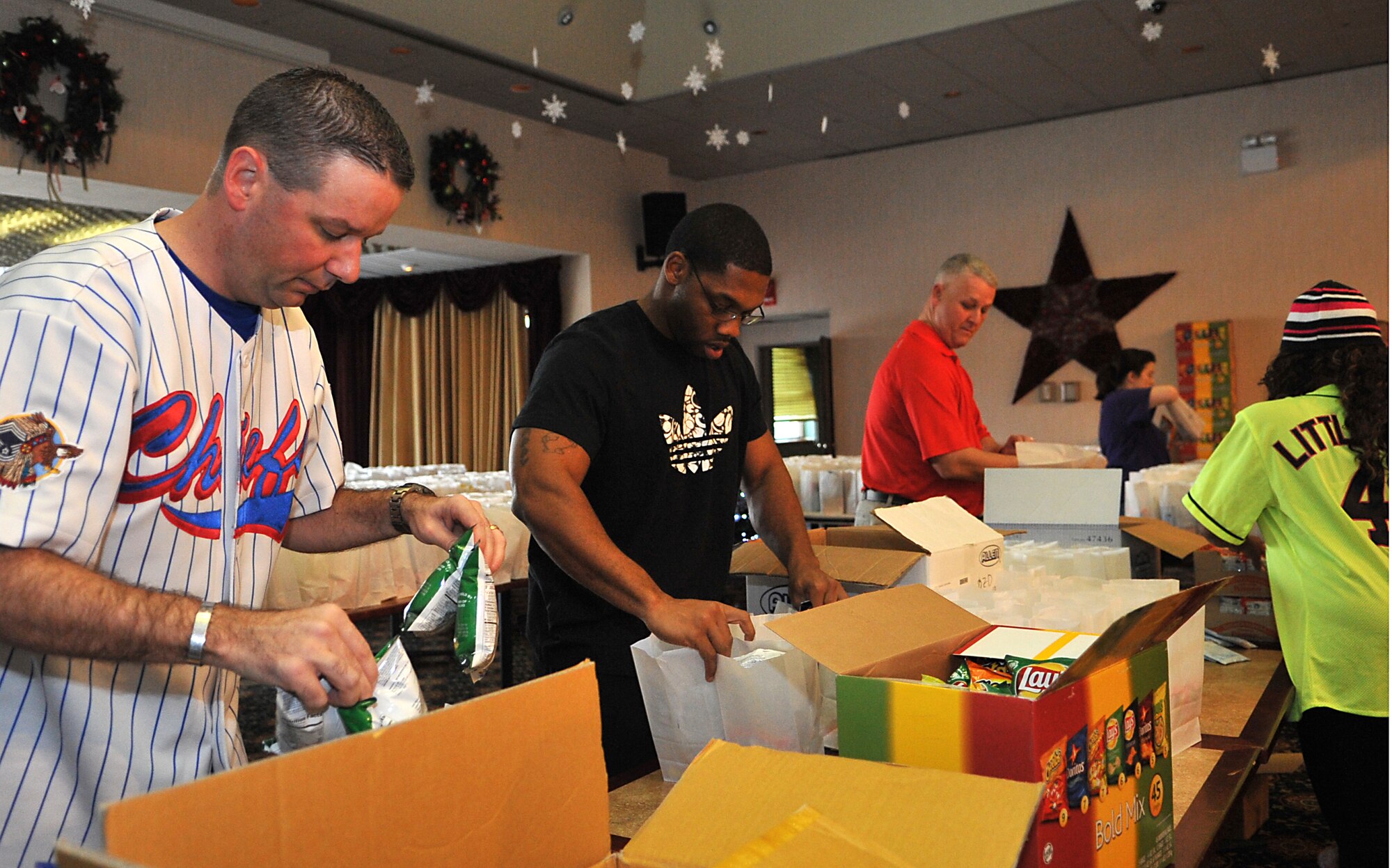 Volunteers from around base put together goodie bags for Operation Sweet Treat in the Officers’ Club at Osan Air Base, Republic of Korea, Dec. 7, 2013. OST is a program hosted by the Enlisted and Officers’ Spouses’ Clubs to bring holiday cheer to unaccompanied service members. (U.S. Air Force photo/Airman 1st Class Ashley J. Thum)