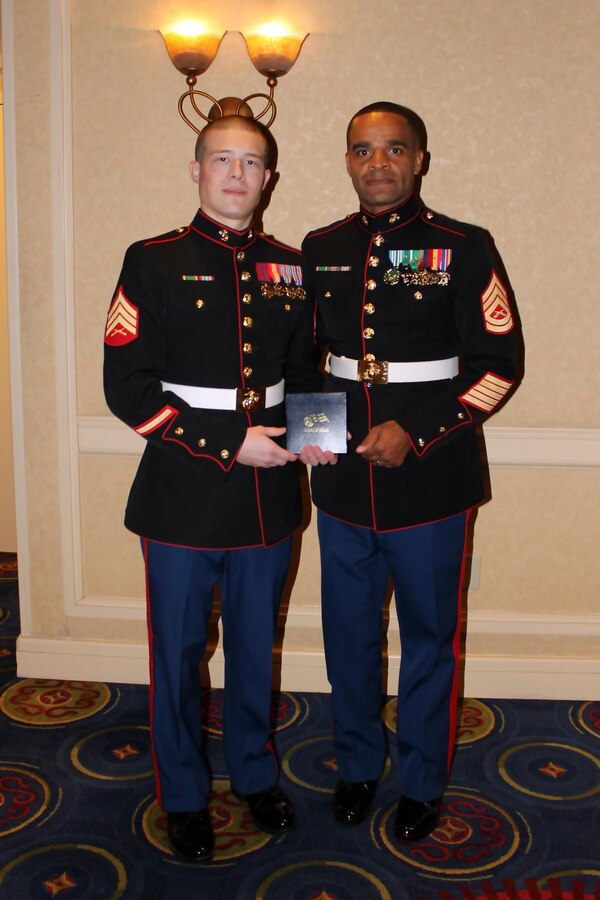 U.S. Marine Corps Sgt. Terrence Taylor, a recruiter in the Princeton, W.Va. area and Defiance, Ohio native, left, displays an award he received from Cedric Greene, the deputy secretary of the Department of Administration and a retired Marine, right, during Recruiting Station Charleston’s Marine Corps Ball Nov. 9, 2013. The award, a Theodore Roosevelt coin, was given to Taylor as a symbol of hard work and dedication while he is serving as a Marine Corps recruiter.  (U.S. Marine Corps photo courtesy of Sgt. Terrence Taylor/Released)