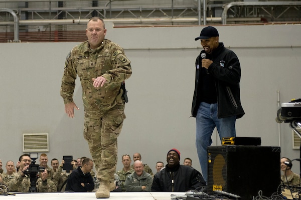 Chairman of the Joint Chiefs Gen Martin E. Dempsey and USO entertainers talk with Soldiers, Sailors, Marines and DOD civilians during a show at Bagram, Afghanistan on Dec 9, 2013. The USO Holiday Tour brought a variety of celebrities on board, including reality television stars Willie and Jep Robertson from "Duck Dynasty," Washington Nationals first-baseman Adam LaRoche, comedian Nephew Tommy, pop singer Bridget Kelly, and actress Allison Haislip. DOD Photo by D. Myles Cullen Digital