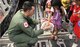 First Lt. Evan Lomeli hands out candy to children as they board a C-17 Globemaster III to be transported Nov. 21, 2013, within the Philippines as part of Operation Damayan. Operation Damayan is a humanitarian aid and disaster relief operation led by the Philippine government and supported by a multinational response force. The transport process was overseen by a joint service operation and the Armed Forces of the Philippines. Lomeli is a C-17 pilot with the 517th Airlift Squadron. (Courtesy photo)