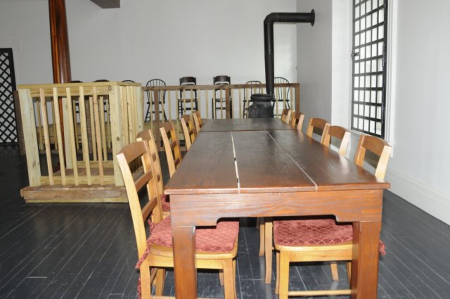 The military commission sat at the table in front of the witness stand. The other conspirators sat in the area on the back wall.  