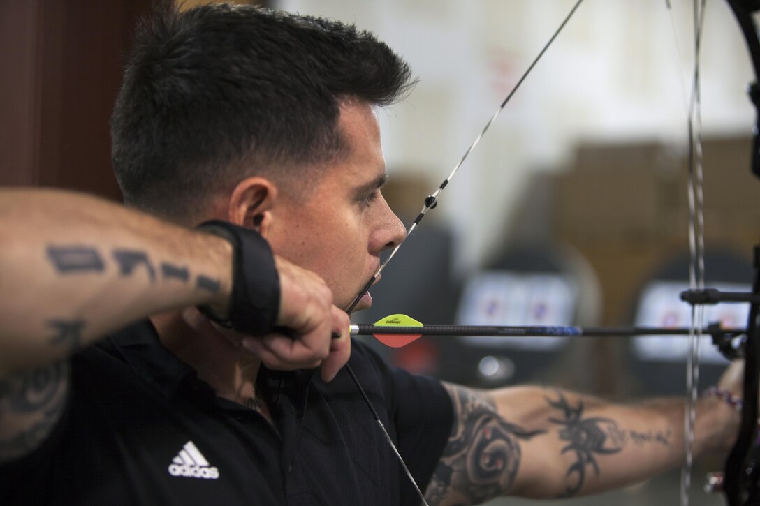 Staff Sgt. Mickey Jaramillo, with Wounded Warrior Battalion East, aims his compound bow on the 20-meter archery range Dec. 4, 2013 in Anniston, Ala. More than 30 Marines and a sailor participated in the four-day archery camp. The Marines and a sailor trained approximately eight hours a day with coaches helping their form. (Marine Corps photo by Lance Cpl. Dylan Bowyer/ Released)