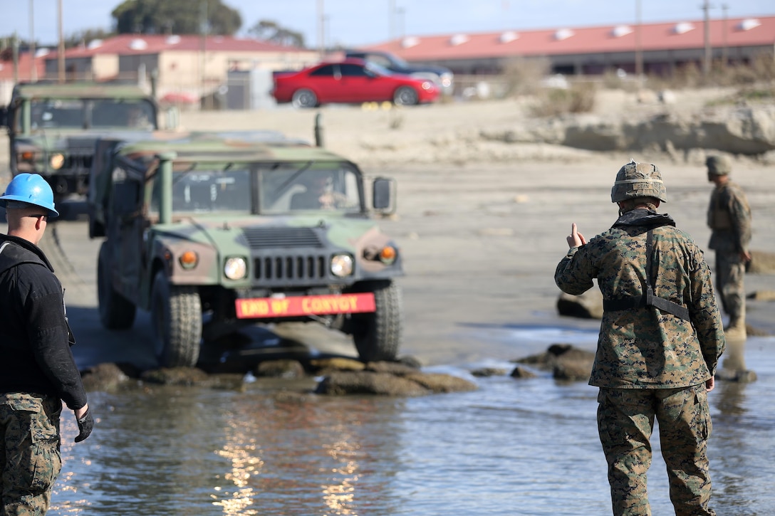 U.S. Marine Lance Cpl. Clint Dean of Pocahontas, Ark. a Combat Engineer with 7th Engineer Support Battalion (ESB), 1st Marine Logistics Group directs a Humvee onboard a 5 bay improved ribbon bridge during rafting operations Dec. 4, 2013 aboard Camp Pendleton Calif. 7th ESB utilizes Improved ribbon bridges to improve mobility by providing continuous roadway or raft capabilities for crossing military vehicles over non fordable water ways. (U.S. Marine Corps Photo by Cpl. Alexander Quiles/Released)