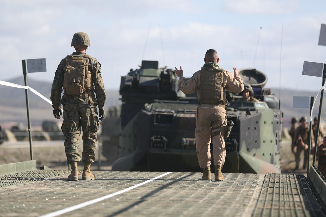 U.S. Marine AAV7A1 assault amphibious vehicles with Headquarters & Service Company (H&S Co.), 3D Assault Amphibious Battalion, 1st Marine Division cross a 10 bay medium girder bridge during training Dec. 4, 2013 aboard Camp Pendleton Calif. Marines with H&S Co. conducted bridging operations with Combat Engineers of Bridge Company, 7th Engineer Support Battalion, 1st Marine Logistics Group on Red Beach to improve unit readiness.