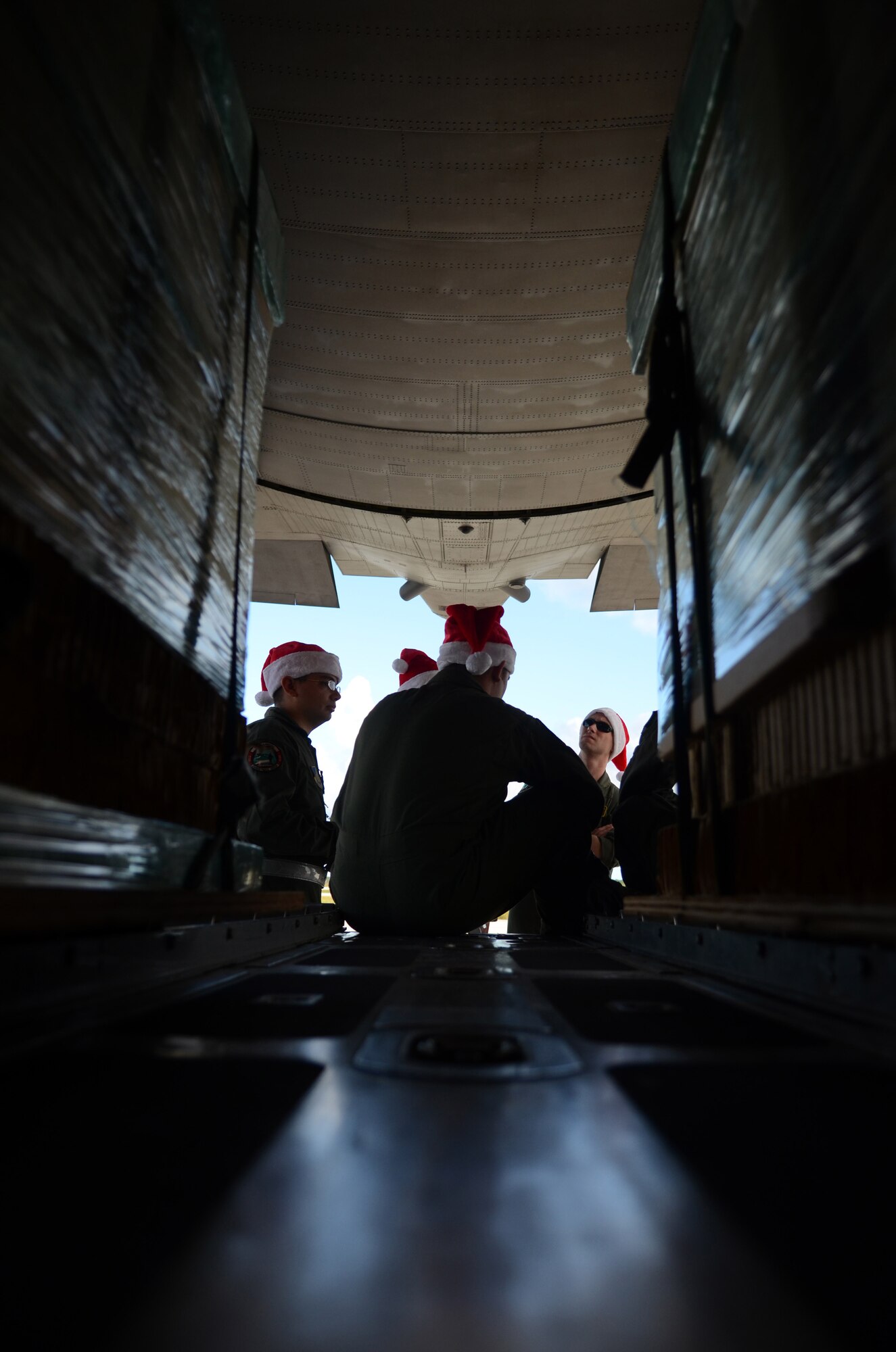 Members of a C-130 Hercules aircrew from Yokota Air Base, Japan, meet at the back of the aircraft to discuss flight plans before an Operation Christmas Drop flight Dec. 11, 2013, on Andersen Air Force Base, Guam. This year marks the 62nd year of Operation Christmas Drop, which began in 1952, making it the world's longest running airdrop mission. (U.S. Air Force photo by Senior Airman Marianique Santos/Released)