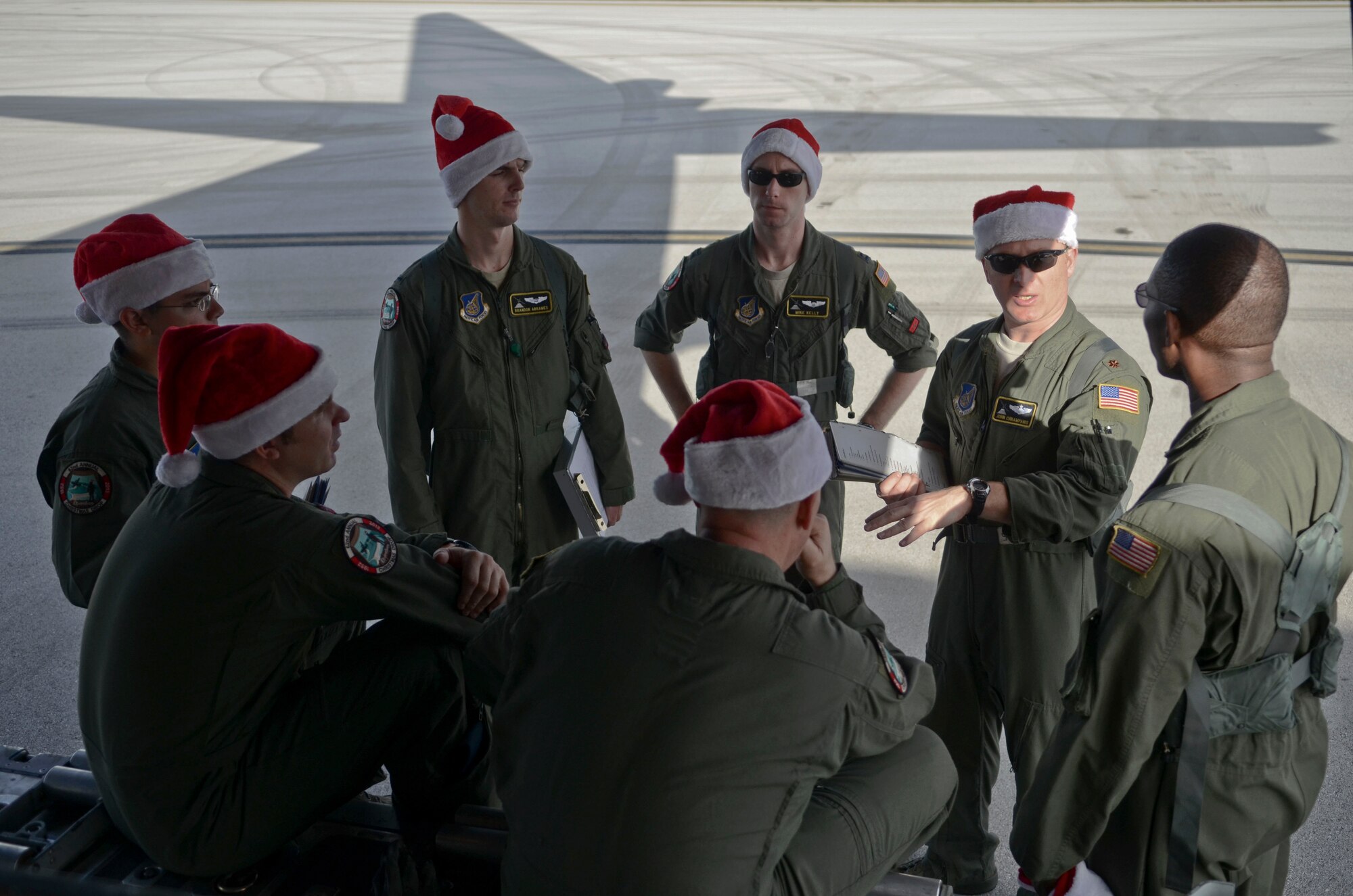 Maj. John Chrampanis, 36th Airlift Squadron C-130 Hercules aircraft commander from Yokota Air Base, Japan, explains the course of the flight to his crew on Andersen Air Force Base, Guam, before an Operation Christmas Drop flight Dec. 11, 2013. Every December, C-130 Hercules aircrews from the 374th Airlift Wing at Yokota AB partner with the 36th Wing at Andersen AFB to airlift food, supplies and toys to islanders throughout Micronesia. (U.S. Air Force photo by Senior Airman Marianique Santos/Released)