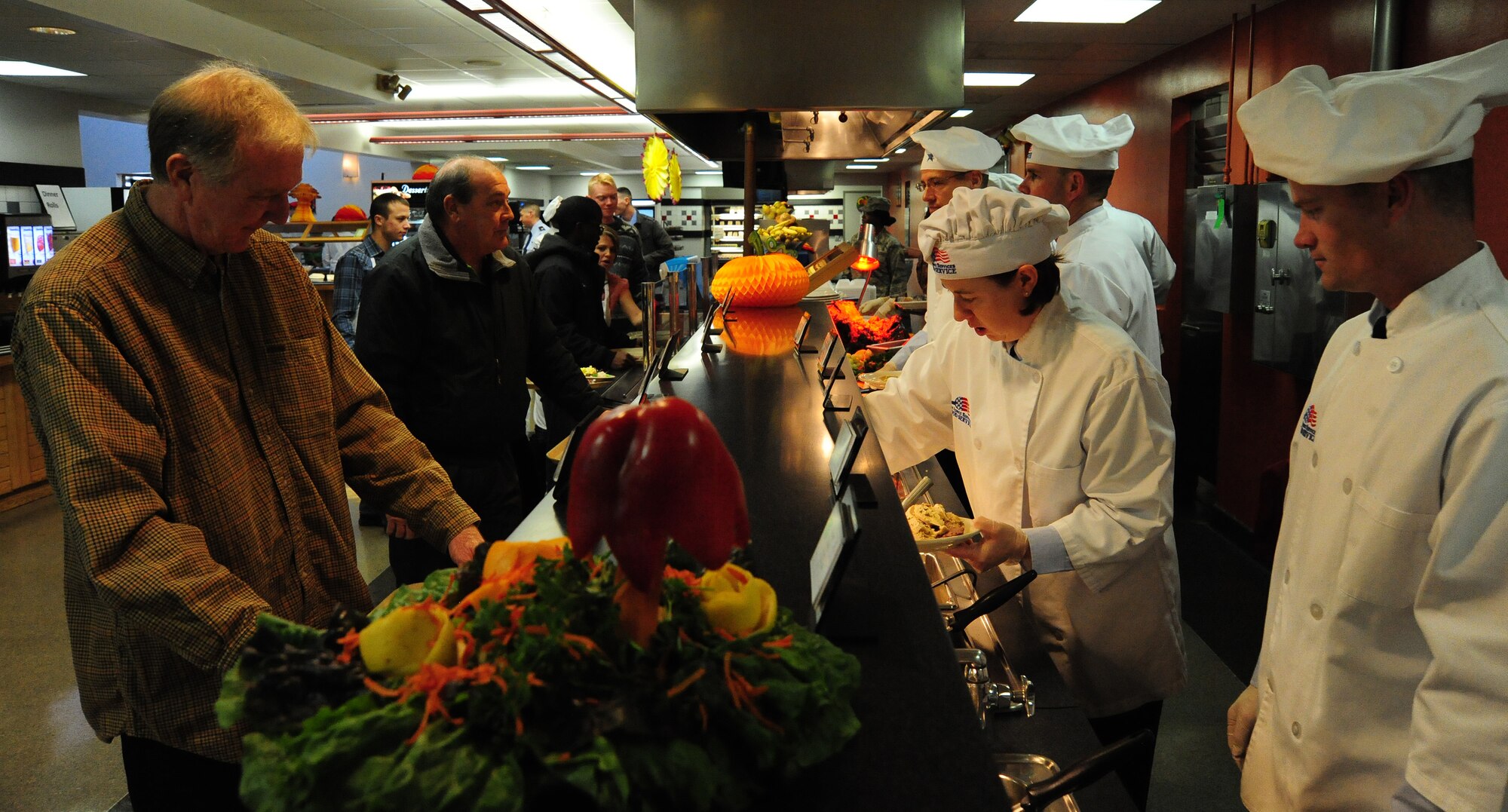 Customers are served by members of the 509th Bomb Wing Leadership during a Thanksgiving luncheon at the Ozark Inn on Whiteman Air Force Base, Mo., Nov. 28, 2013. During the luncheon Airmen were treated to traditional Thanksgiving foods such as turkey, stuffing, peas, carrots, corn and mashed potatoes. (U.S. Air Force photo by Staff Sgt. Nick Wilson/Released)