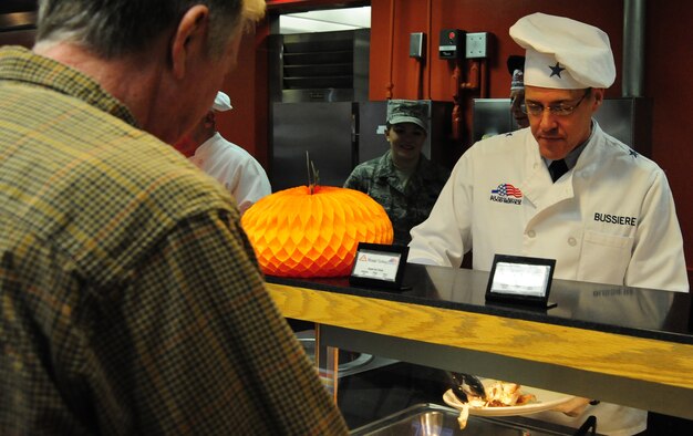 U.S. Air Force Brig. Gen. Thomas Bussiere, 509th Bomb Wing commander, serves a plate of food for retired U.S. Air Force Chief Master Sgt. Tommy Russel during a Thanksgiving luncheon at the Ozark Inn on Whiteman Air Force Base, Mo., Nov. 28, 2013. The luncheon was available to Service members, retirees and dependents.  (U.S. Air Force photo by Staff Sgt. Nick Wilson/Released)