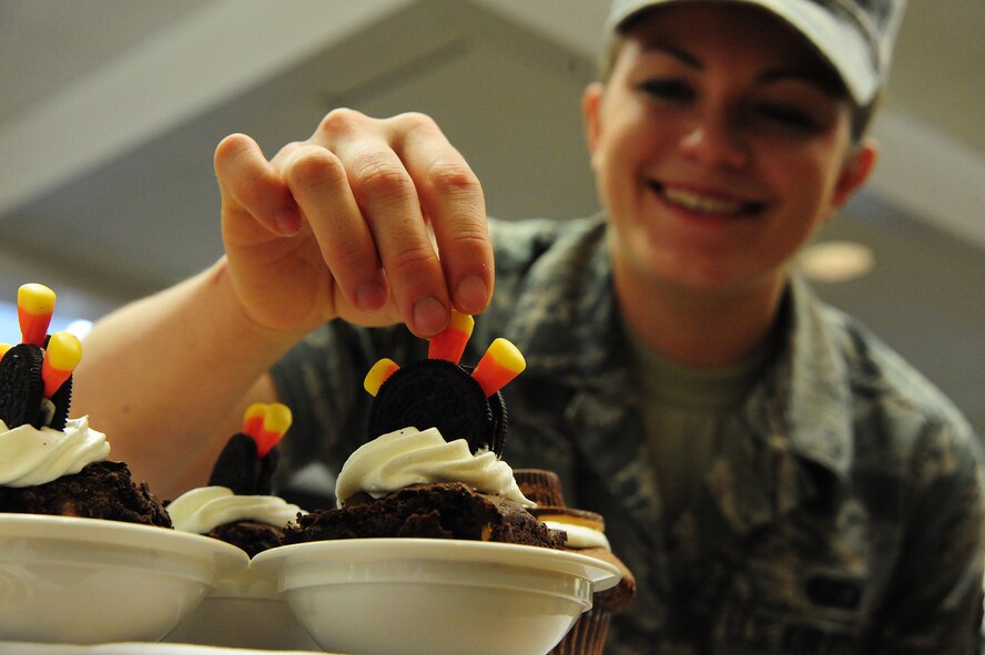 U.S. Air Force Airman 1st Class Amy Klavitzer, 509th Force Support Squadron food service apprentice, applies finishing touches to a peanut butter chocolate chip brownie during a Thanksgiving luncheon at the Ozark Inn on Whiteman Air Force Base, Mo., Nov. 28, 2013. The event was put on to boost morale for Airmen that are working through the holidays and can’t make it home to their families. (U.S. Air Force photo by Staff Sgt. Nick Wilson/Released)